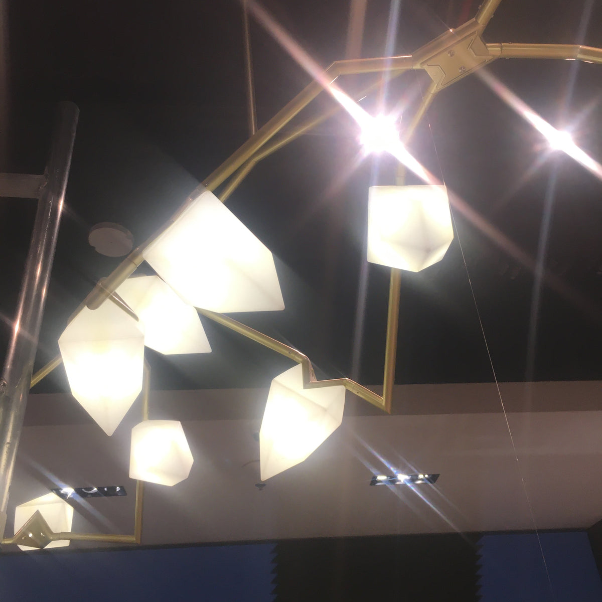 Display item of the Masko 12-heads chandelier by Beacon, showcasing the elegant, modern design with multiple hanging light fixtures.