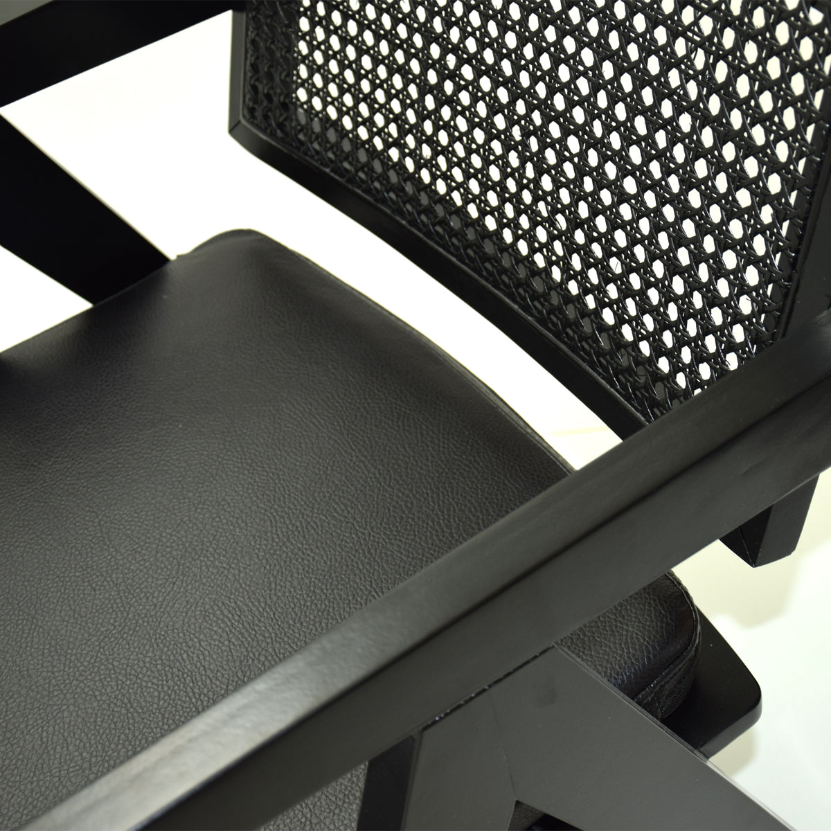 Black SANCREA Moes armchair with corded upholstery, modern chair with plush cushioning and sleek design.