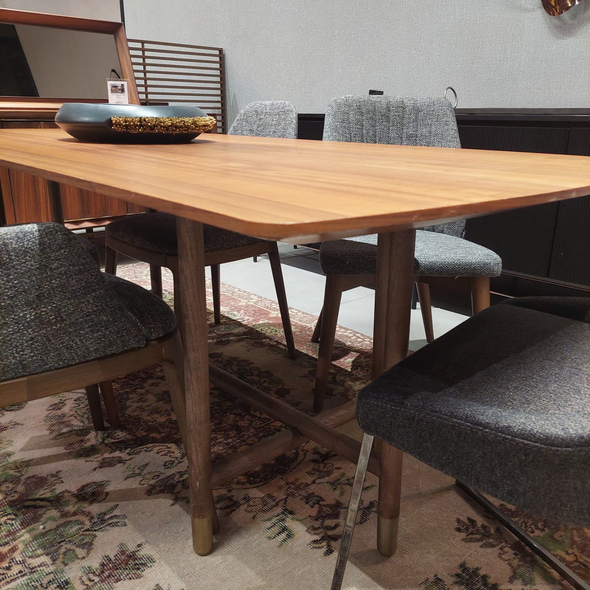 Display image of the Pietra Dining Table by HOMAGE KOLTUK, showcasing its modern design and wooden finish.