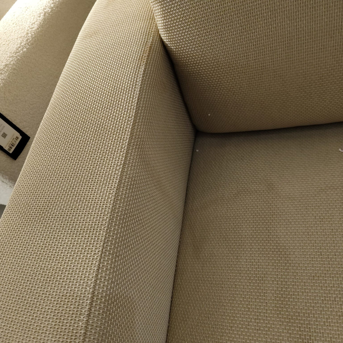 Loda Furniture Vega Armchair display model with beige fabric upholstery and wooden legs on a plain background.