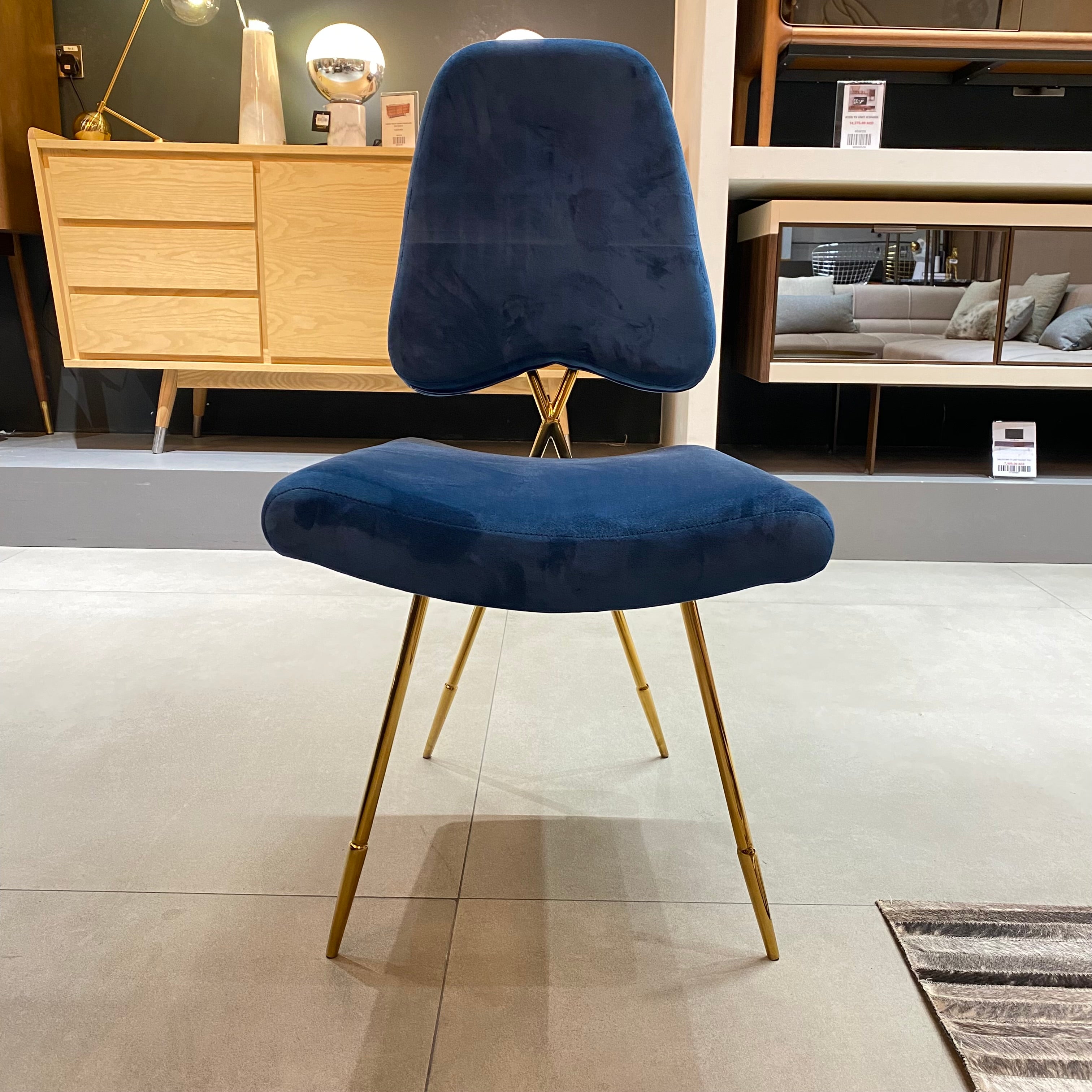 Display of a Velletri Cross dining chair by Beacon, showing the chair's stylish design and wooden frame.