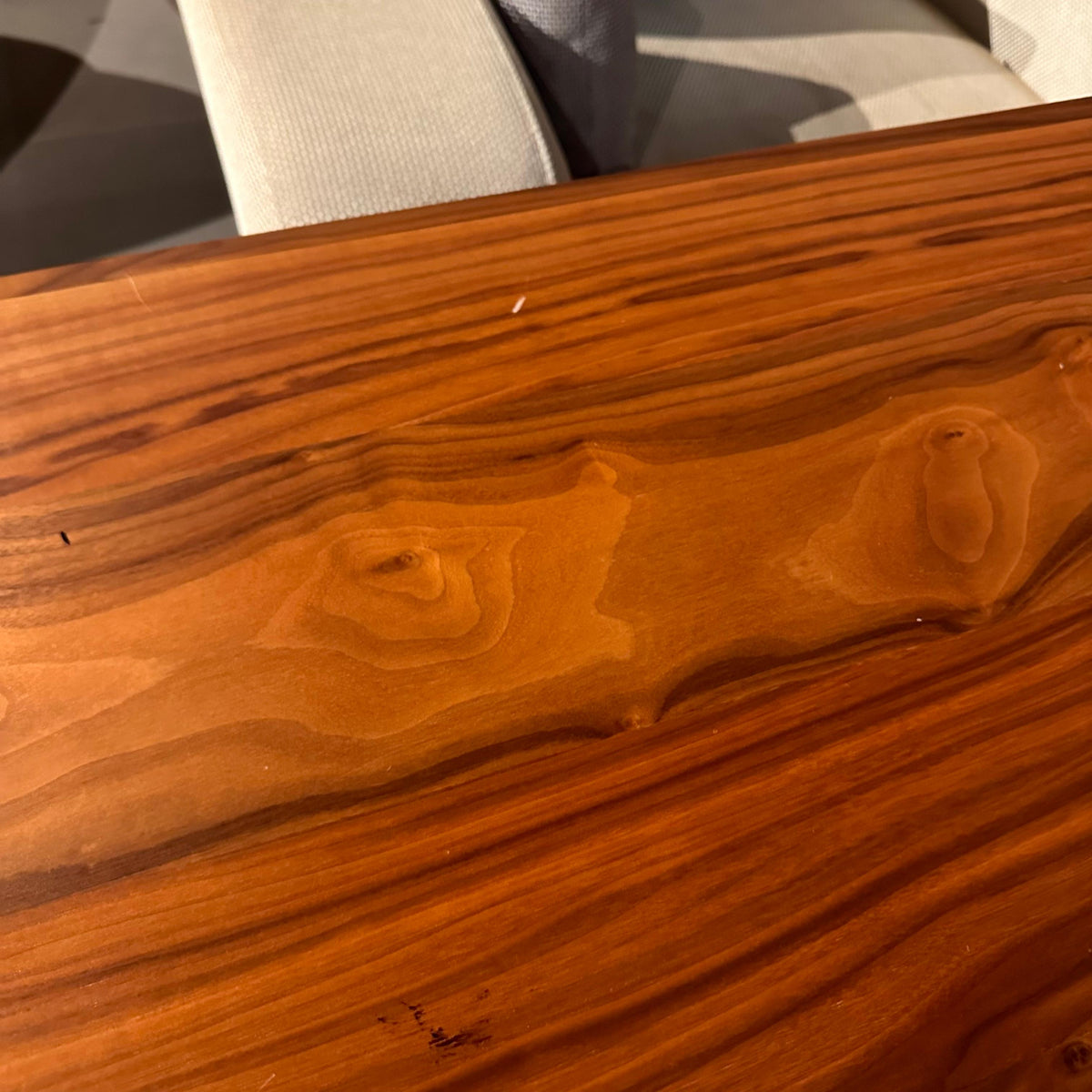 YOL LIVING Genova Dining Table display piece showing a sleek wooden table with a modern design and natural finish.