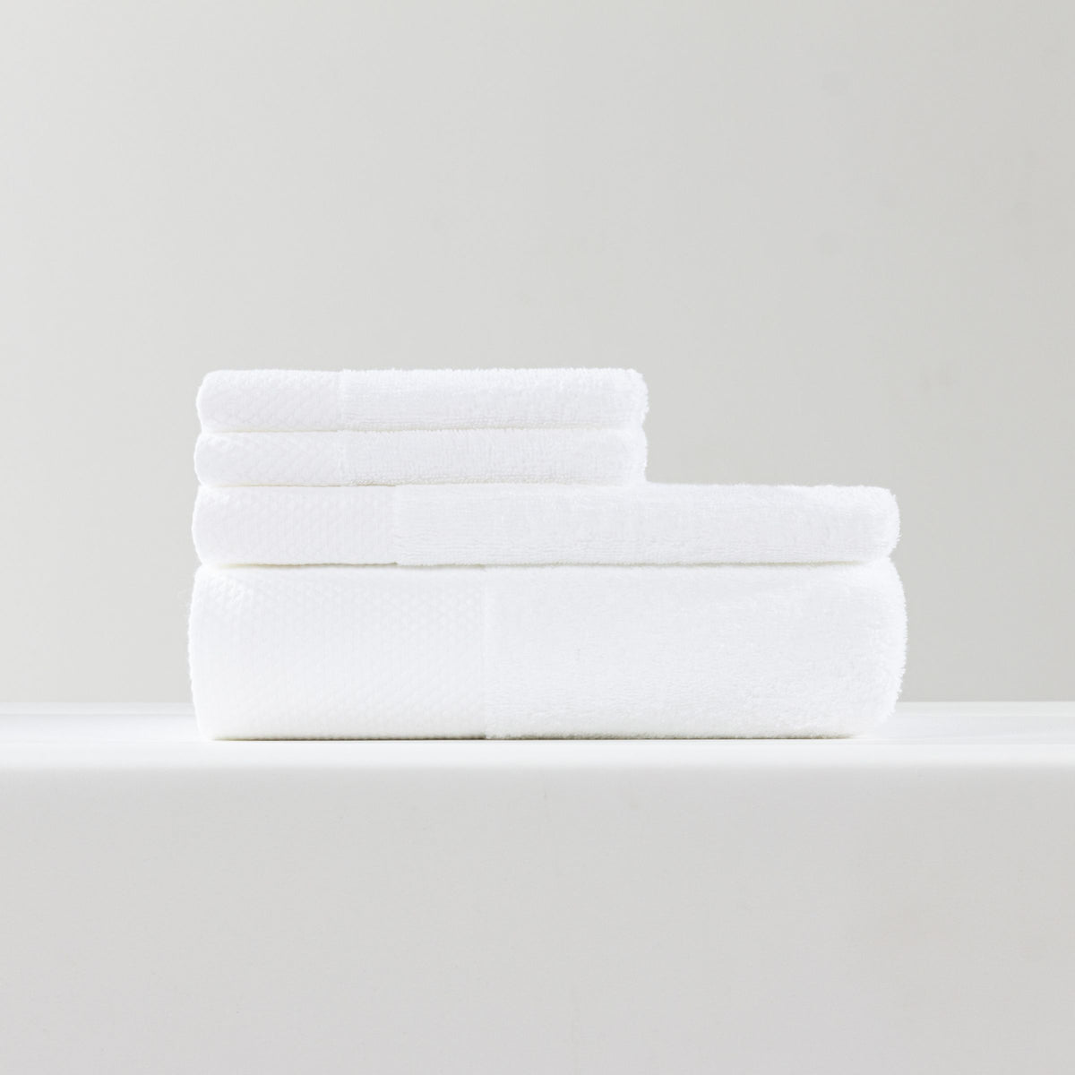 Set of ebarza Dobby Border Towels by BEACON, featuring intricate border design and soft fabric, perfect for bathroom use.