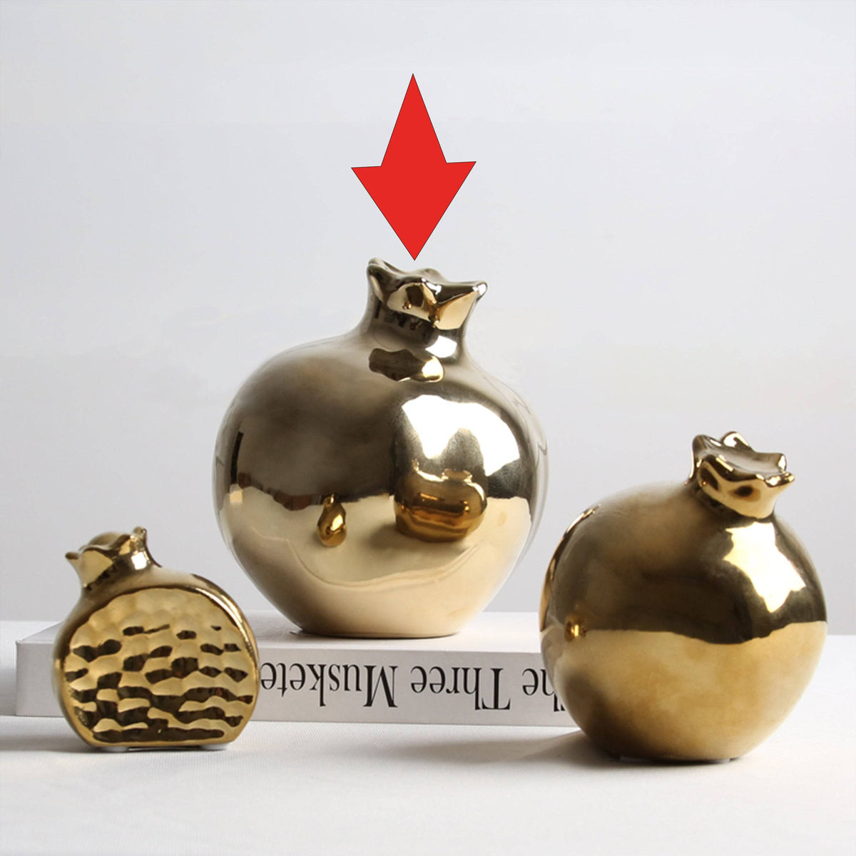 Golden pomegranate home decor figurine by BEACON, decorative ornament with a shiny golden finish for interior accents.