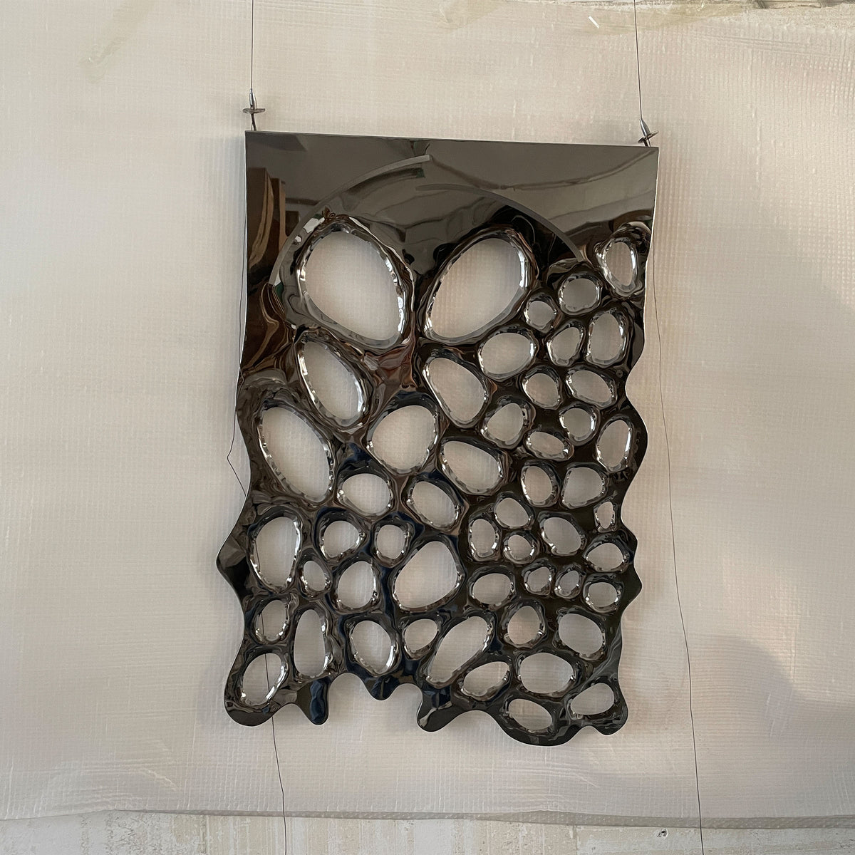 Hand-crafted stainless steel artwork by BEACON, featuring intricate metal design with modern artistic details.