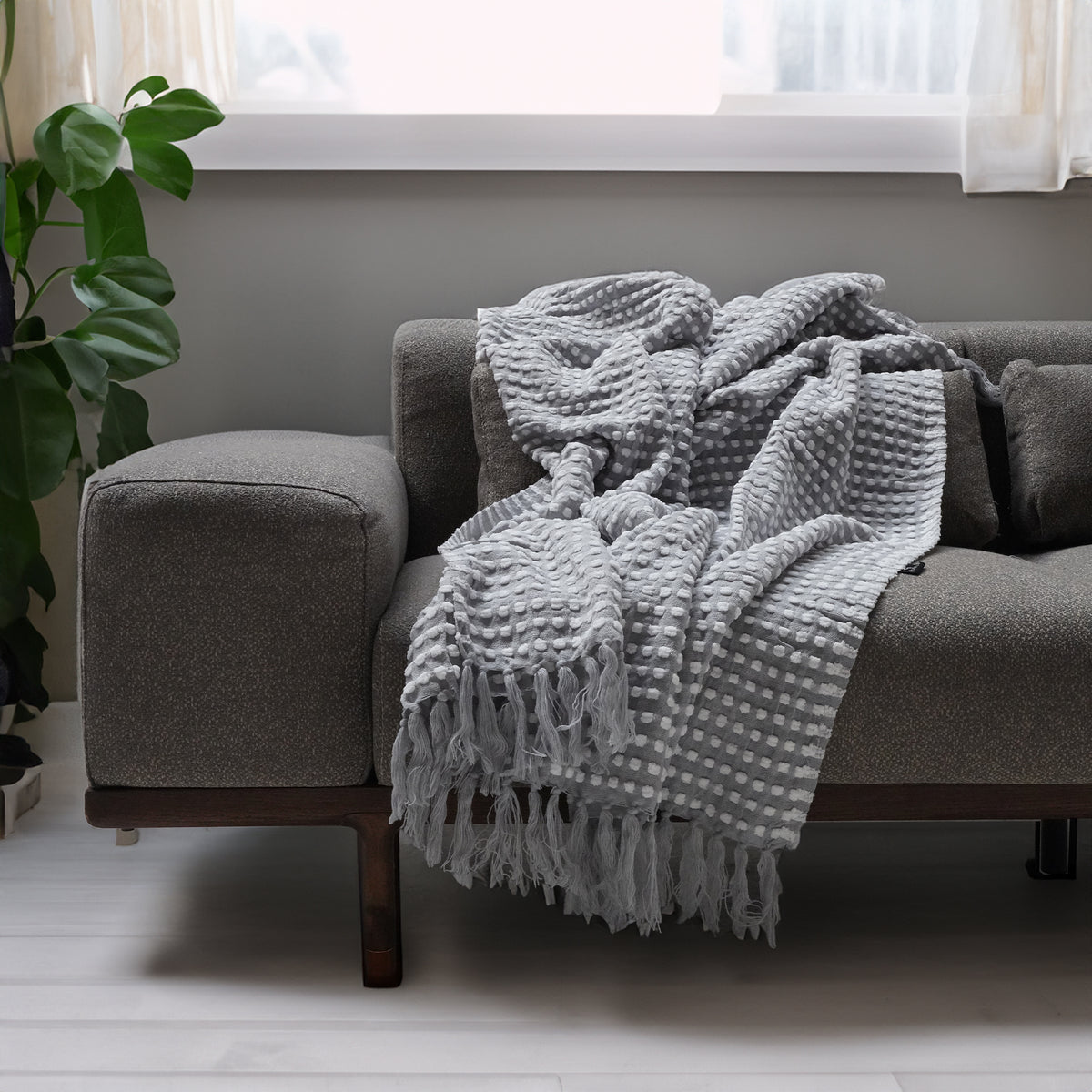 Handmade gray throw blanket from BEACON, soft and cozy with a textured knit pattern, perfect for home decor.