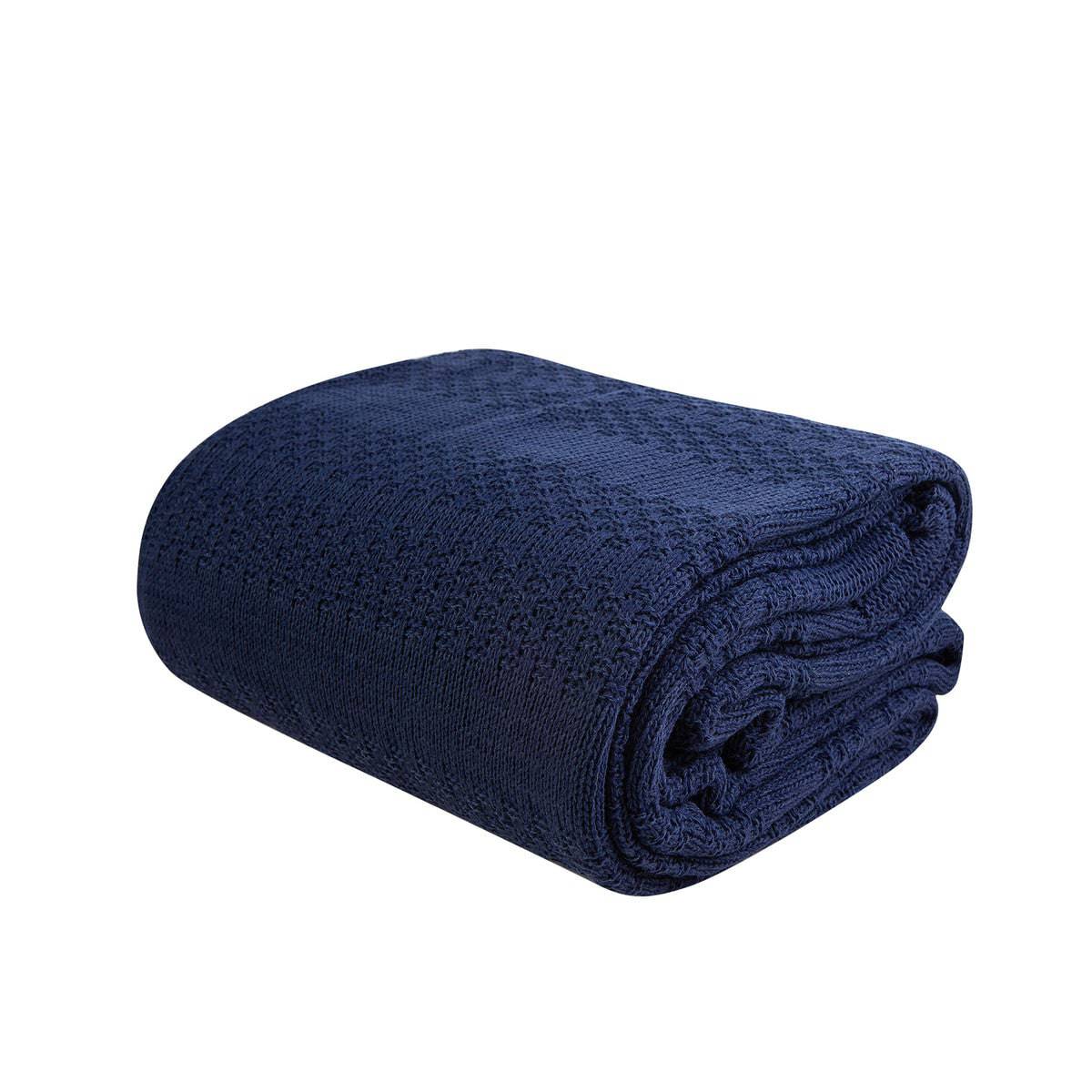 Navy blue Karaca Home Charm Bold double knit blanket spread on bed, showcasing its soft, cozy texture and stylish design.