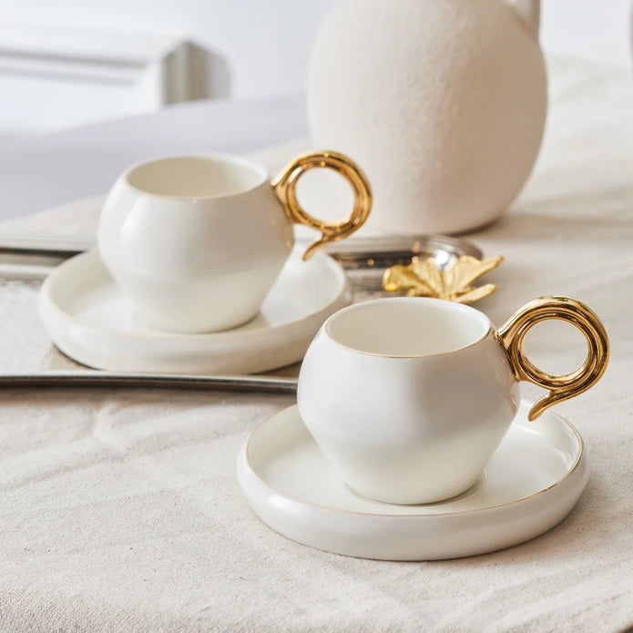 Set of 2 Karaca Venus Gold coffee cups, 135 ml, featuring elegant gold accents, perfect for serving coffee in style.