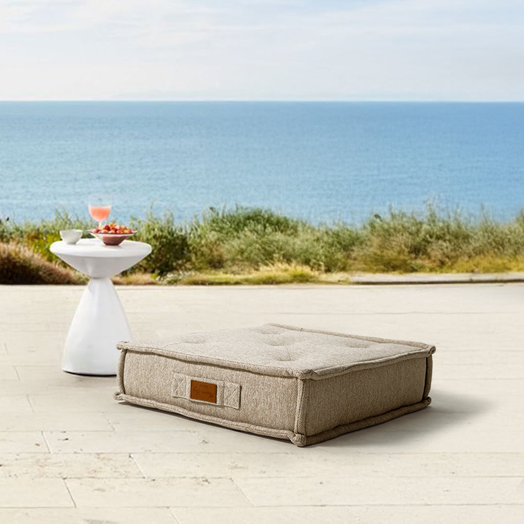 Beige La Concha pouf by BEACON with compressed foam, round upholstered seating with a stylish, modern design.
