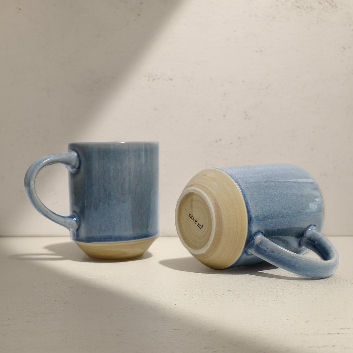 Light blue BEACON mug with a smooth finish, designed for hot beverages, featuring a comfortable handle and modern style.