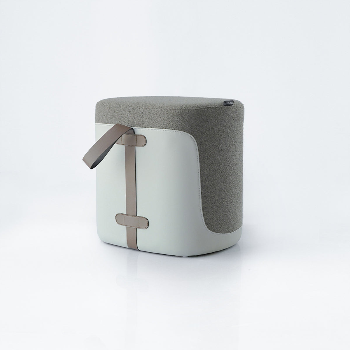 Grey Nomad fabric and PU pouf by BEACON, versatile seating with modern design, shown in a contemporary living space.