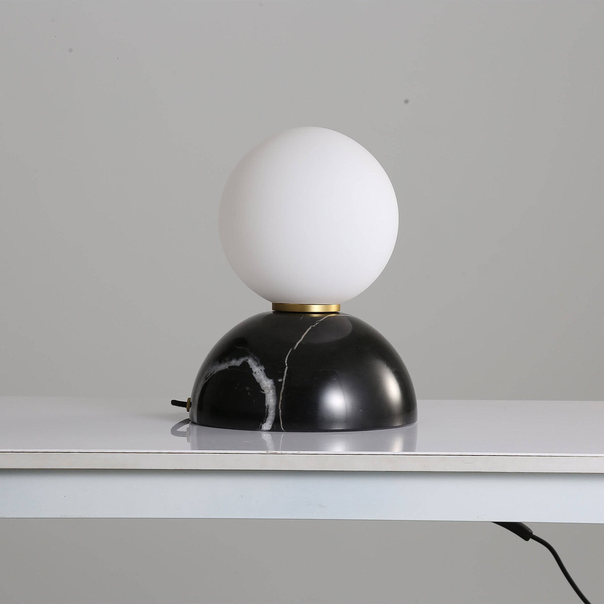 BEACON black marble base table lamp with opal glass shade, ideal for desk or table lighting.