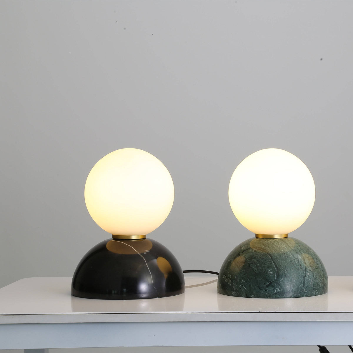 Opal glass shade with black marble base desk lamp by BEACON, modern table lamp for bedside or office decor.