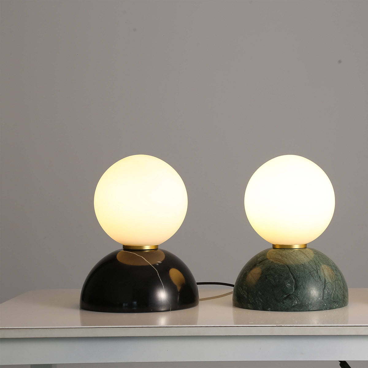 Opal glass shade and black marble base table lamp by BEACON, suitable for desk or table lighting.