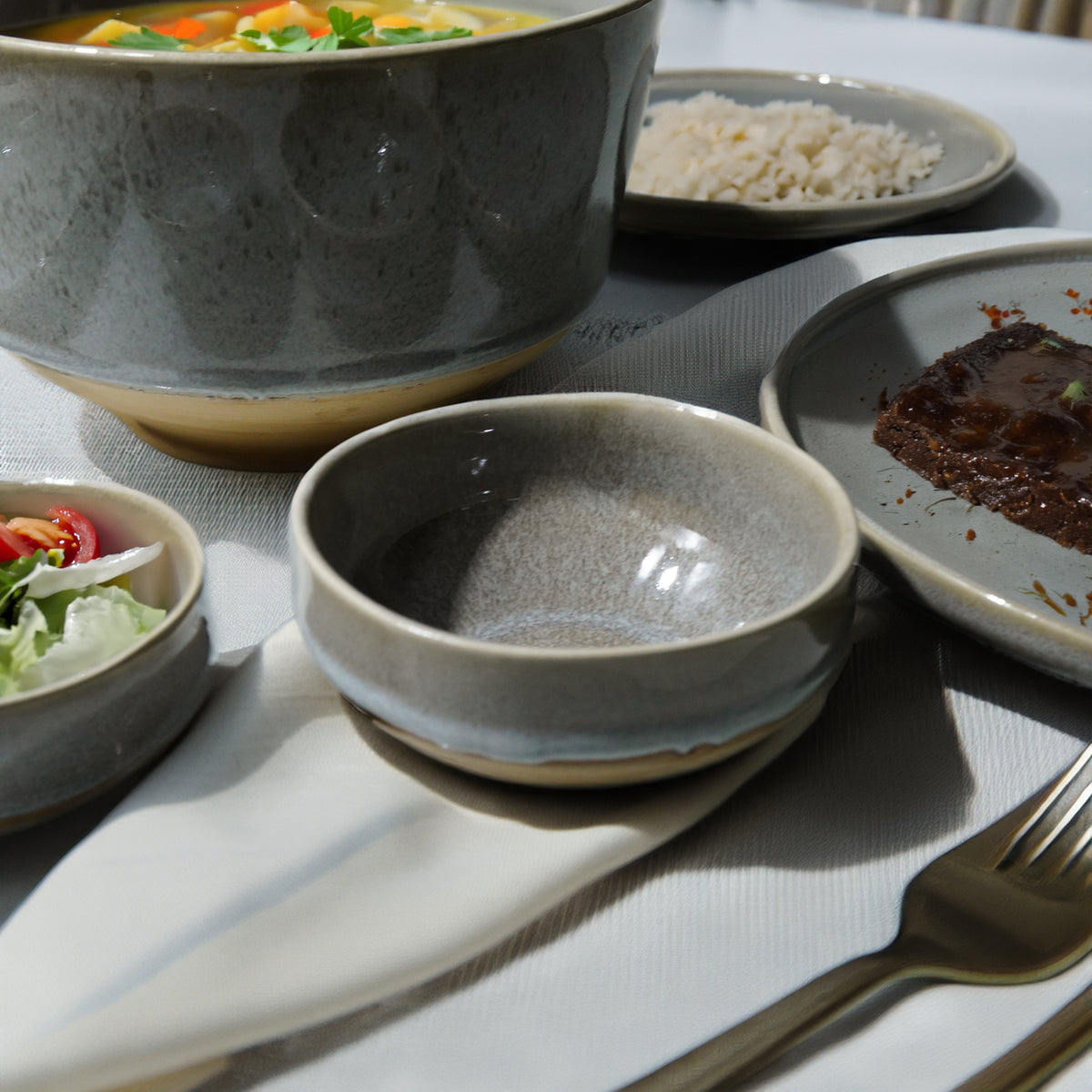 Gray Passifoy serving dish by BEACON, featuring a sleek bowl design for serving food in a modern kitchen.