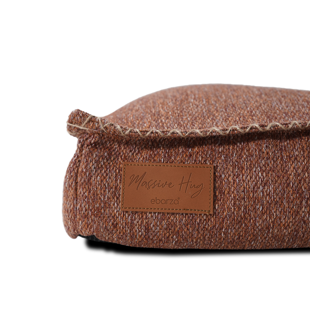 Large orange BEACON pouf pet bed with soft, cushioned surface for comfortable resting.