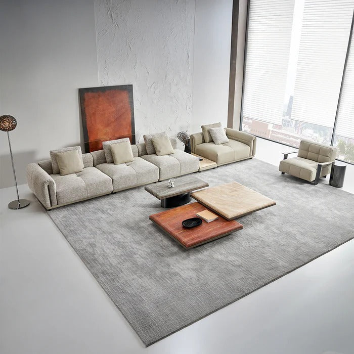 BEACON Quadro 6 Seater sofa in fabric with plush cushions, modern design, and spacious seating arrangement.