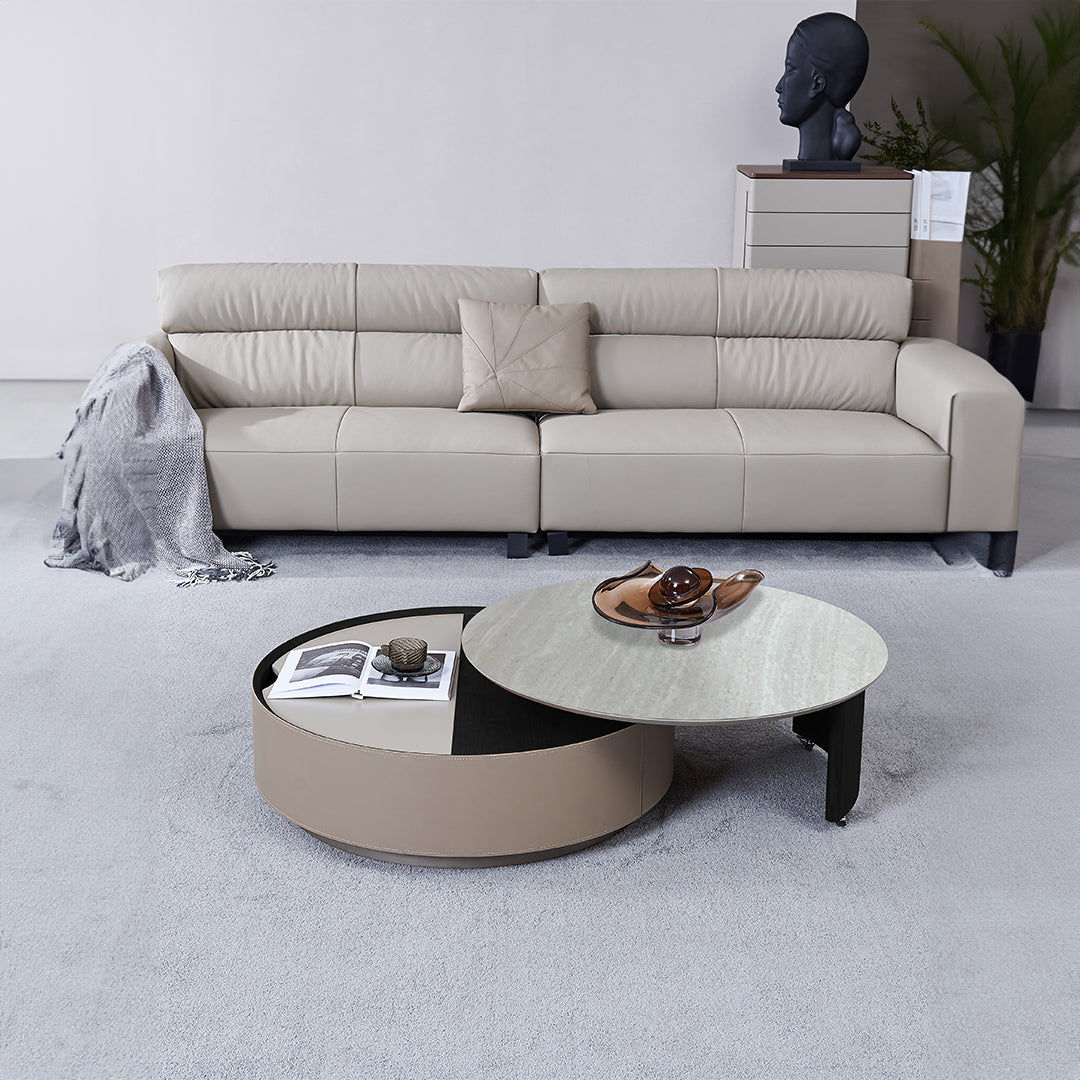 Display of BEACON saddle leather and marble coffee table with a sleek design and polished marble surface.