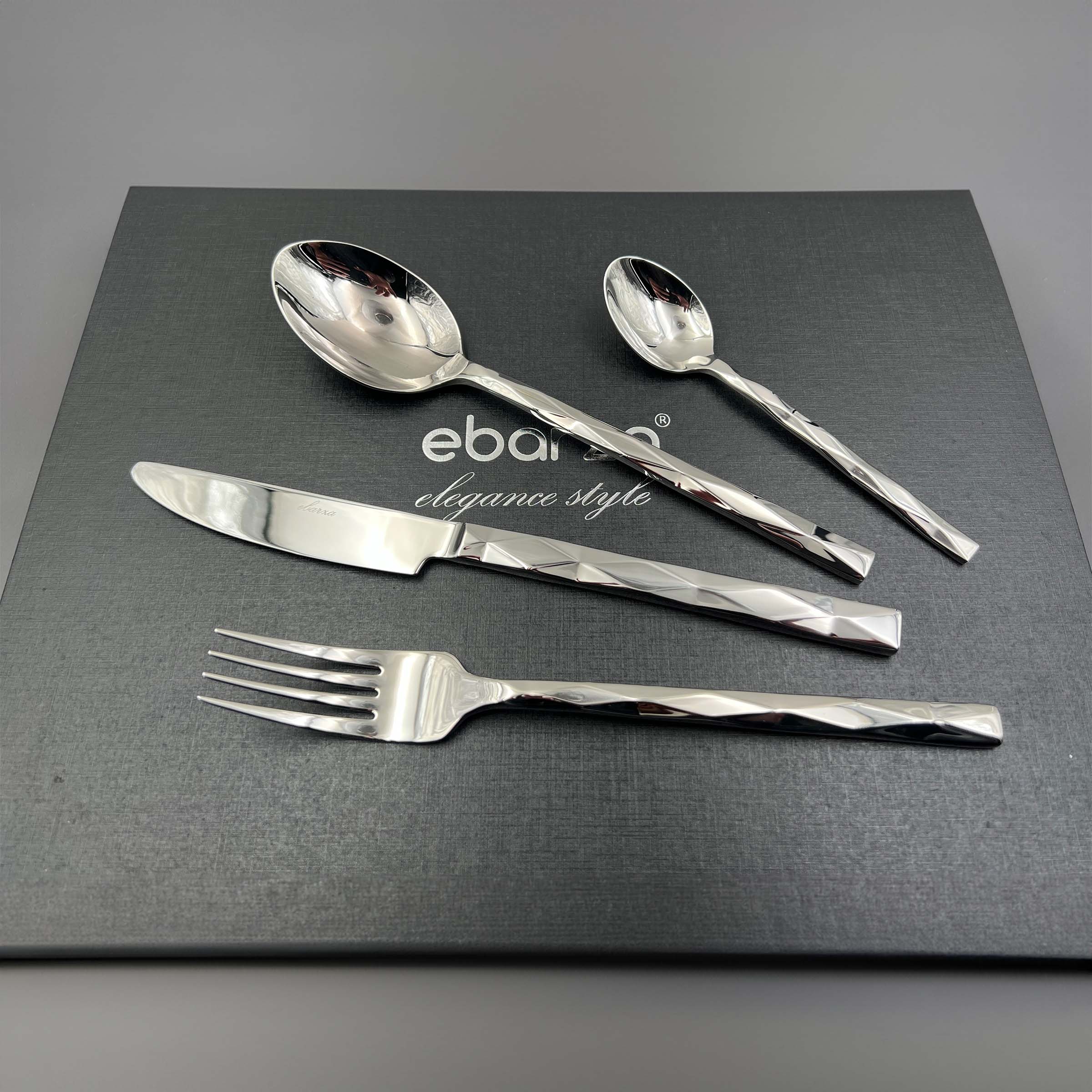 Silhouette set of 24 BEACON mirror silver cutlery including forks, knives, and spoons arranged on a table.