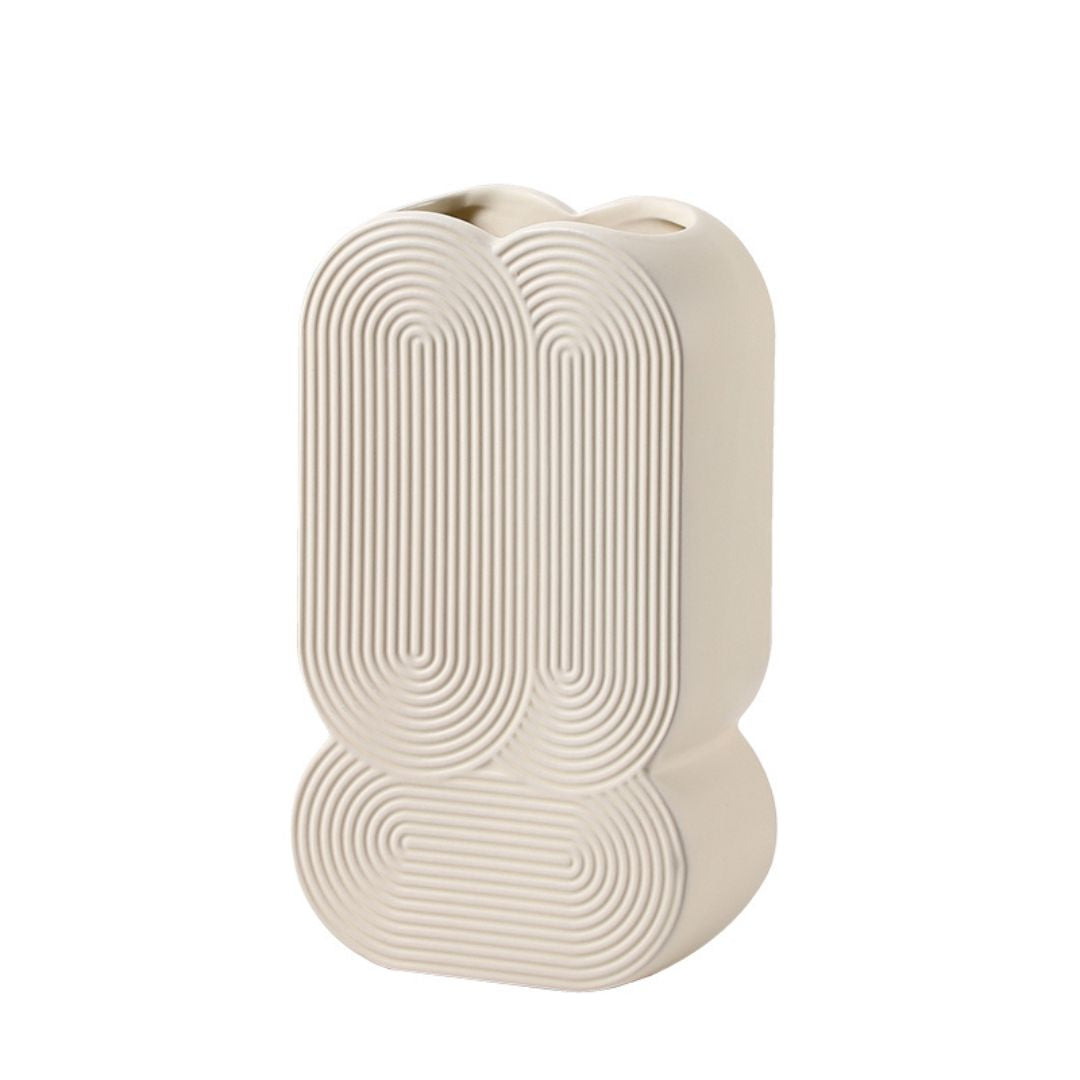 Beige ceramic vase with a spiral pattern, designed by BEACON, ideal for decorative floral arrangements.