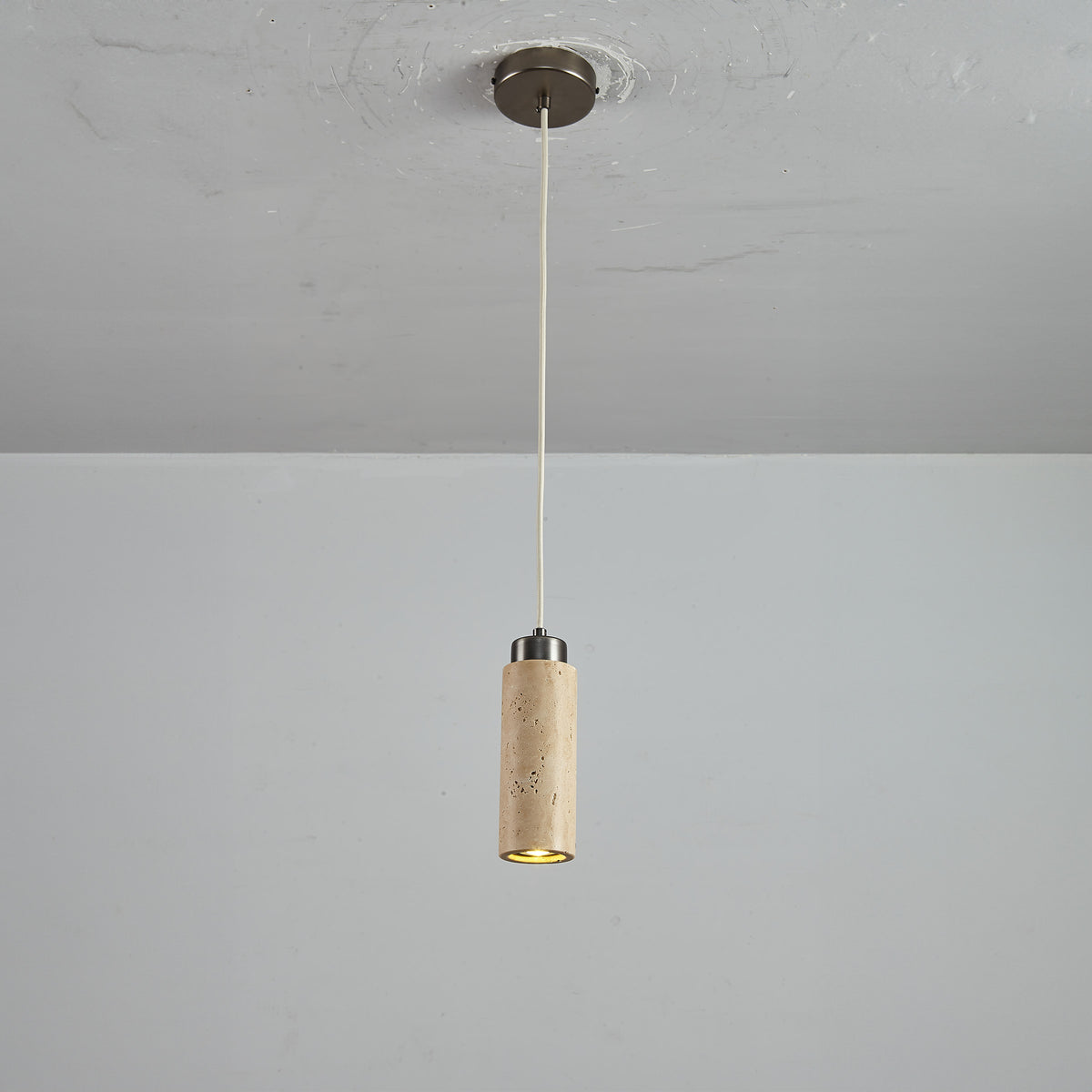 BEACON JIADG travertine pendant lamp 60005-1P with a sleek, natural stone design hanging from a ceiling mount.