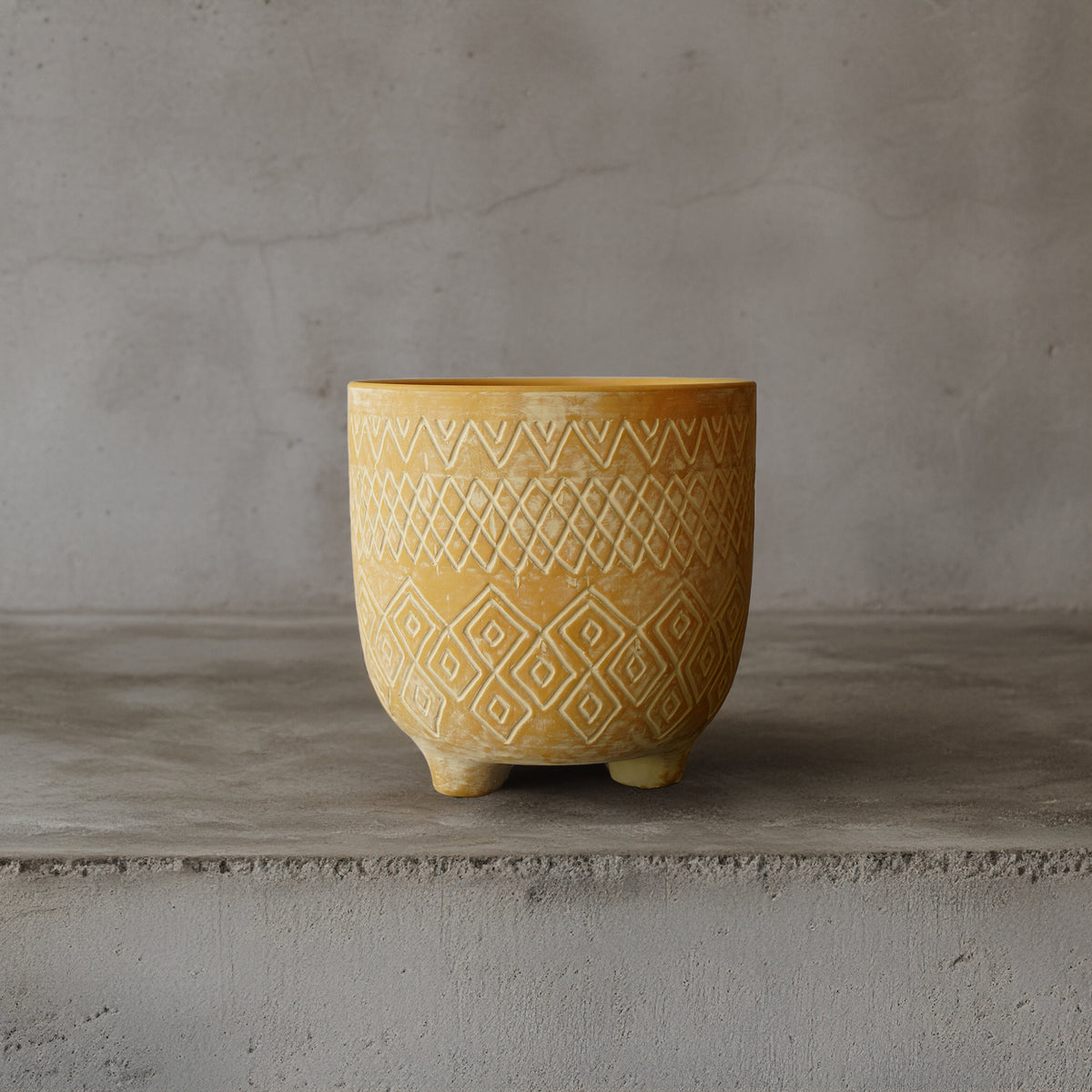Triangular terracotta planter box for outdoor or indoor use by BEACON, featuring a modern geometric design.