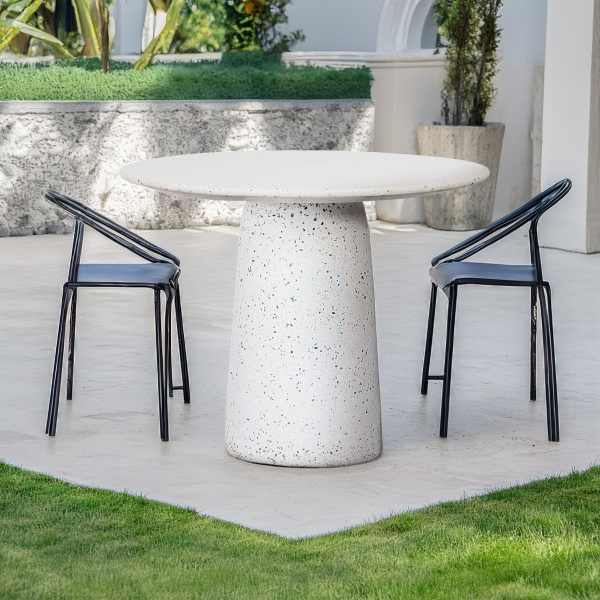 White terrazzo dining table by BEACON, modern dining table with sleek white terrazzo surface and sturdy legs.