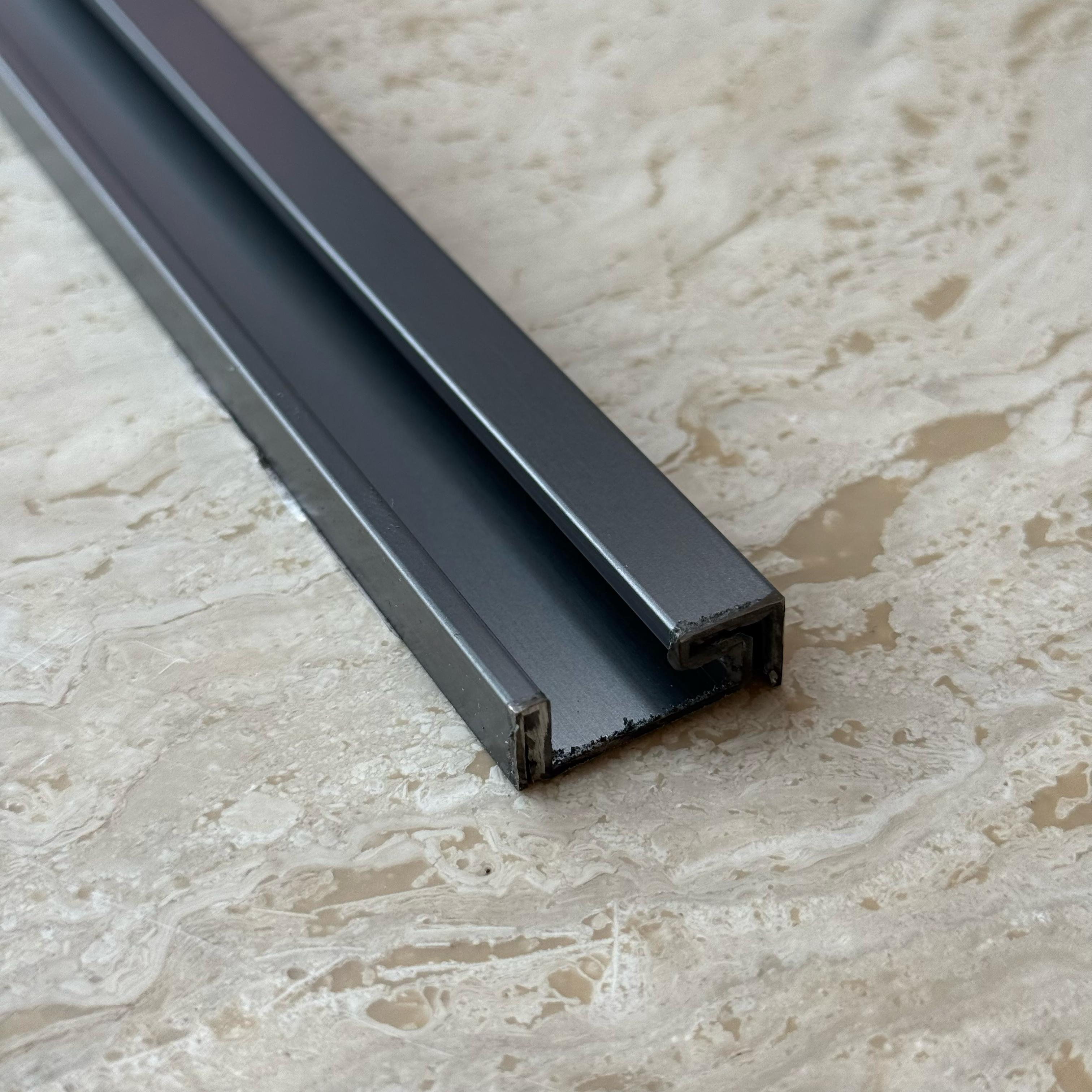 Black stainless steel skirting profile, 0.8mm thick, 2.5cm height, for wall panels and profiles by BEACON.
