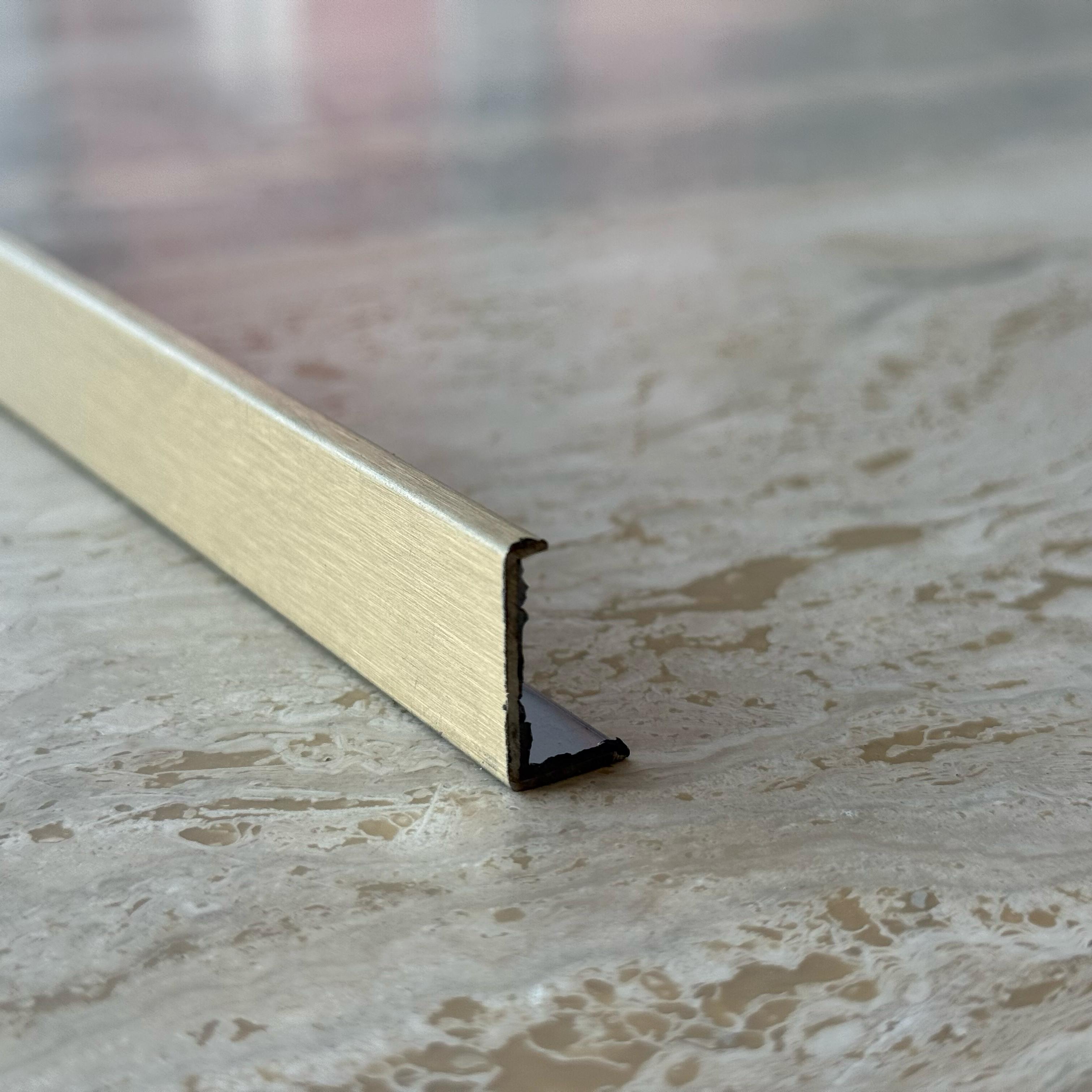 Gold stainless steel perforated profile, 0.8mm thick, designed for MDF wall panels, by BEACON, model PR0059.