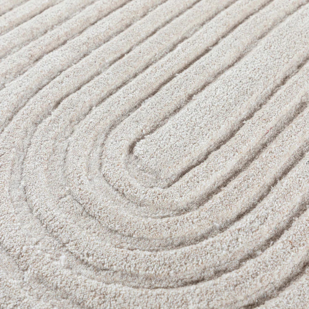 Beige wool rug measuring 60x90 cm from Javi, with soft textured fibers and a cozy, natural look.