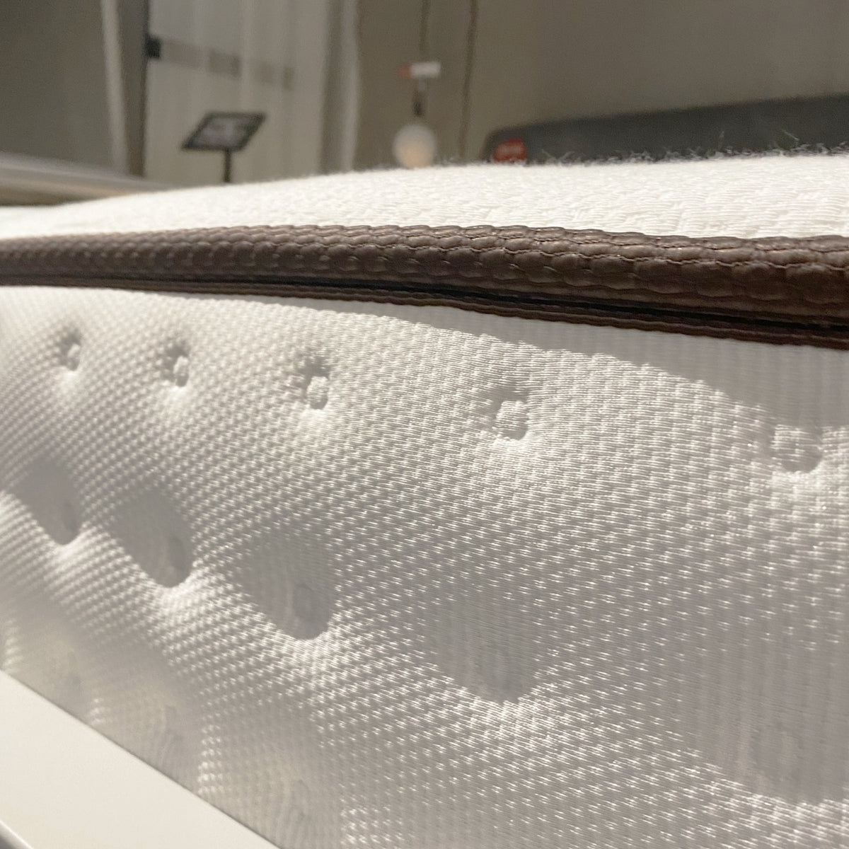 Display of a 180x200 cm latex king size mattress by Beacon, showing the plush, white surface and supportive edges.