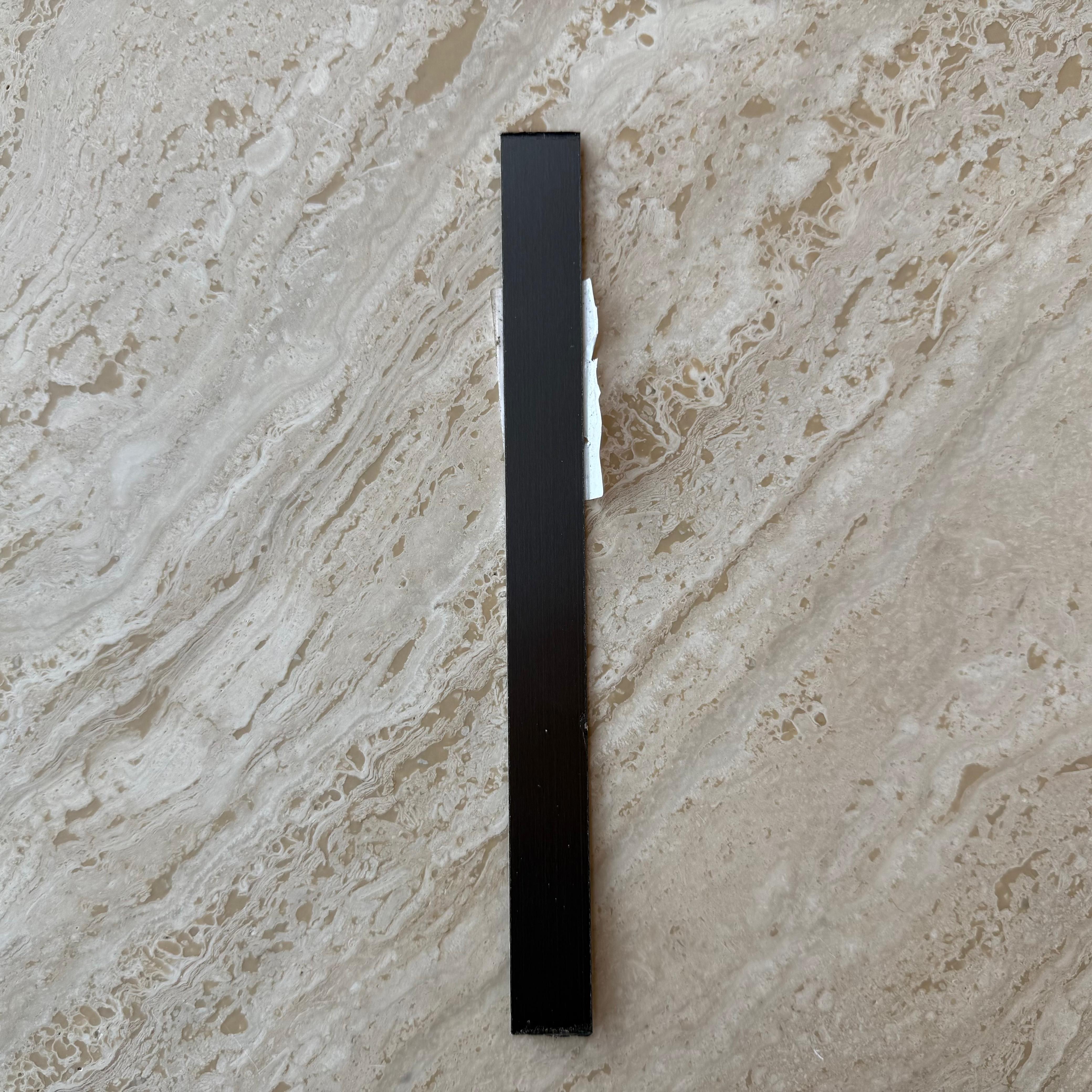 Black stainless steel profile wall panel, 1mm thickness, 1.8cm width, modern construction or interior design material.