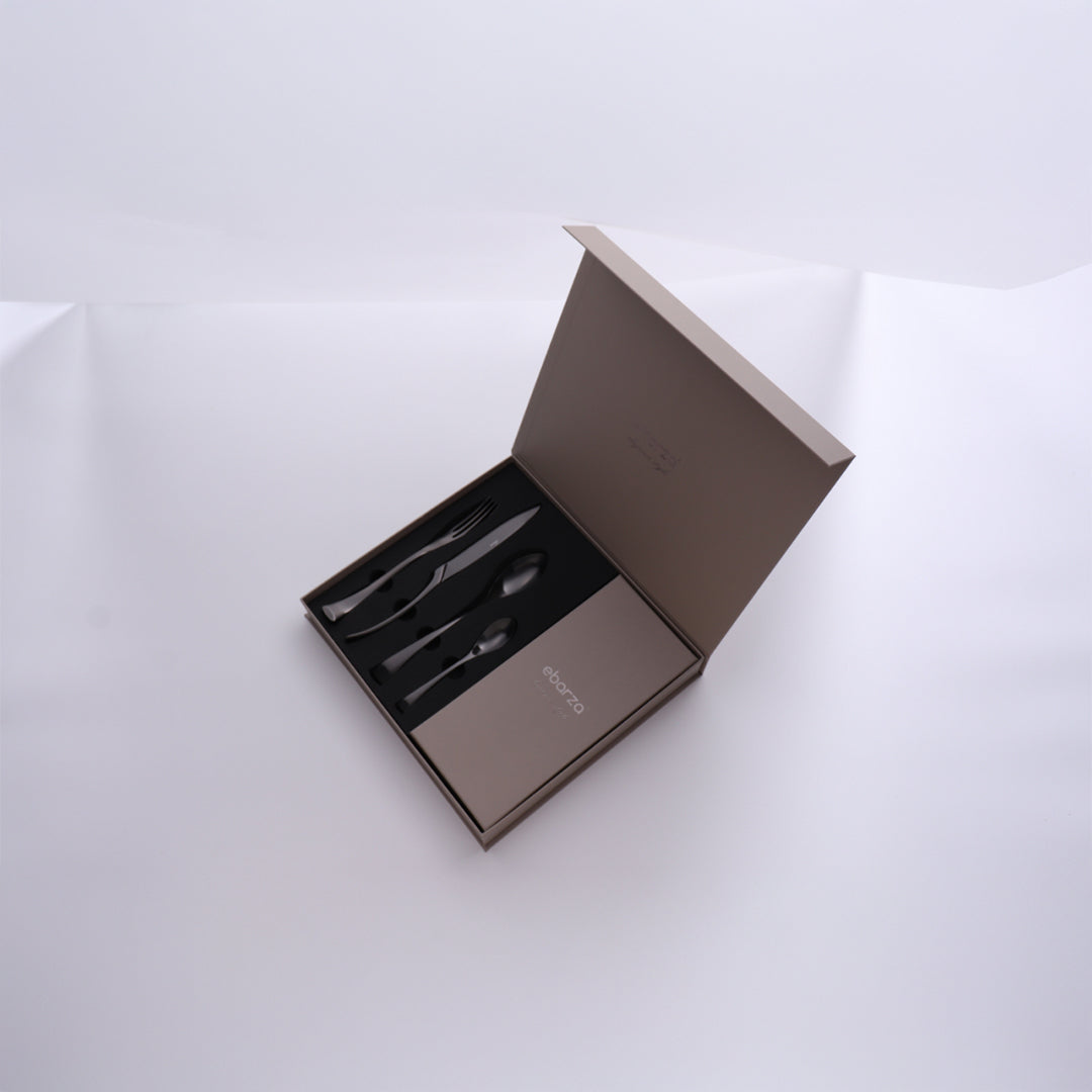 Set of 24 BEACON Noble Cutlery Set 8034MB with stainless steel forks, knives, and spoons arranged on a dining table.