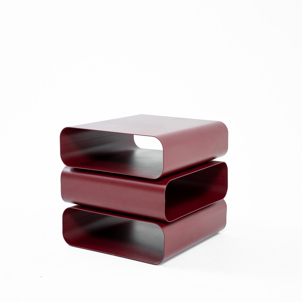 Three-layer claret side table from RUDI, modern bedside table with multiple storage levels, sturdy design and vibrant color.