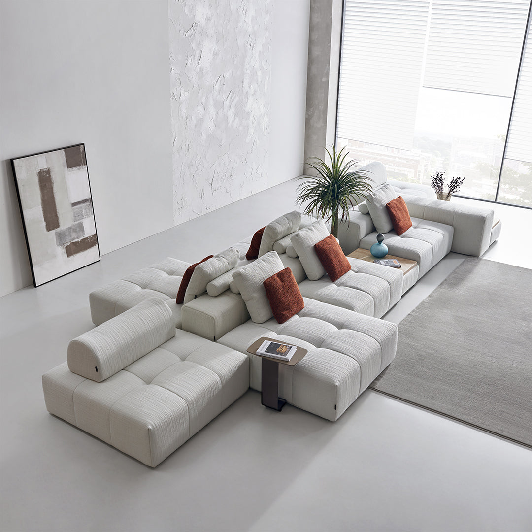 BEACON 3-seater puzzle sofa with matching side table, modern living room furniture, upholstered in neutral fabric.