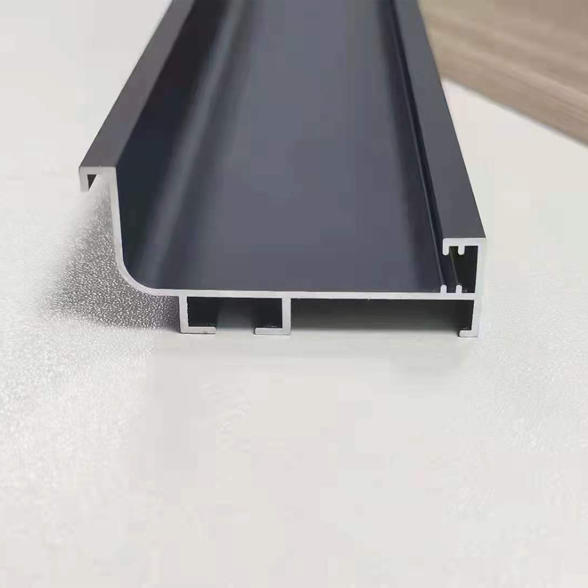 Black 330cm L-shape aluminum handle profile for wall panels, 6cm wide, without LED light, by BEACON.