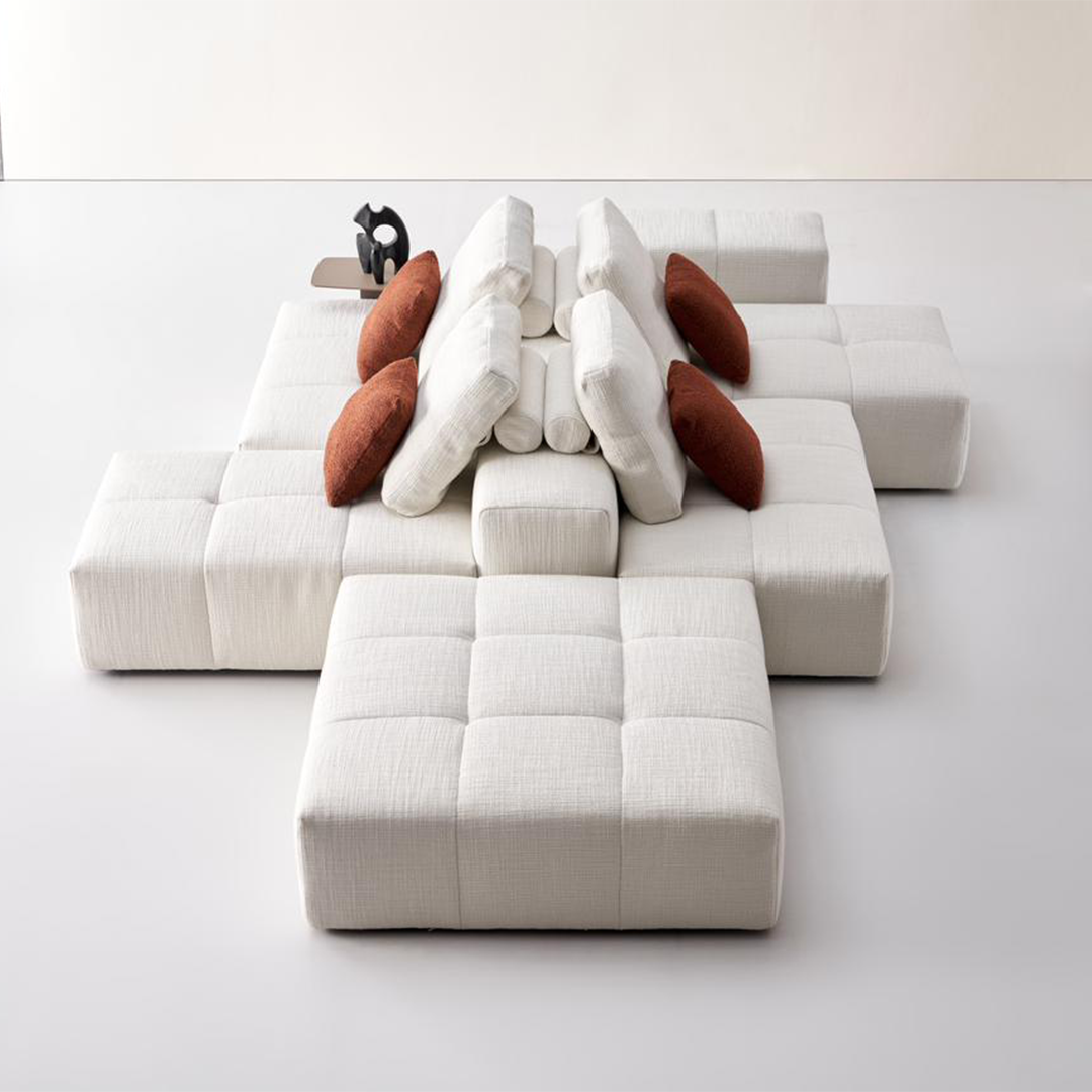 Square 45x45 cm modular cushion for sofas by BEACON, featuring puzzle piece design in vibrant fabric.