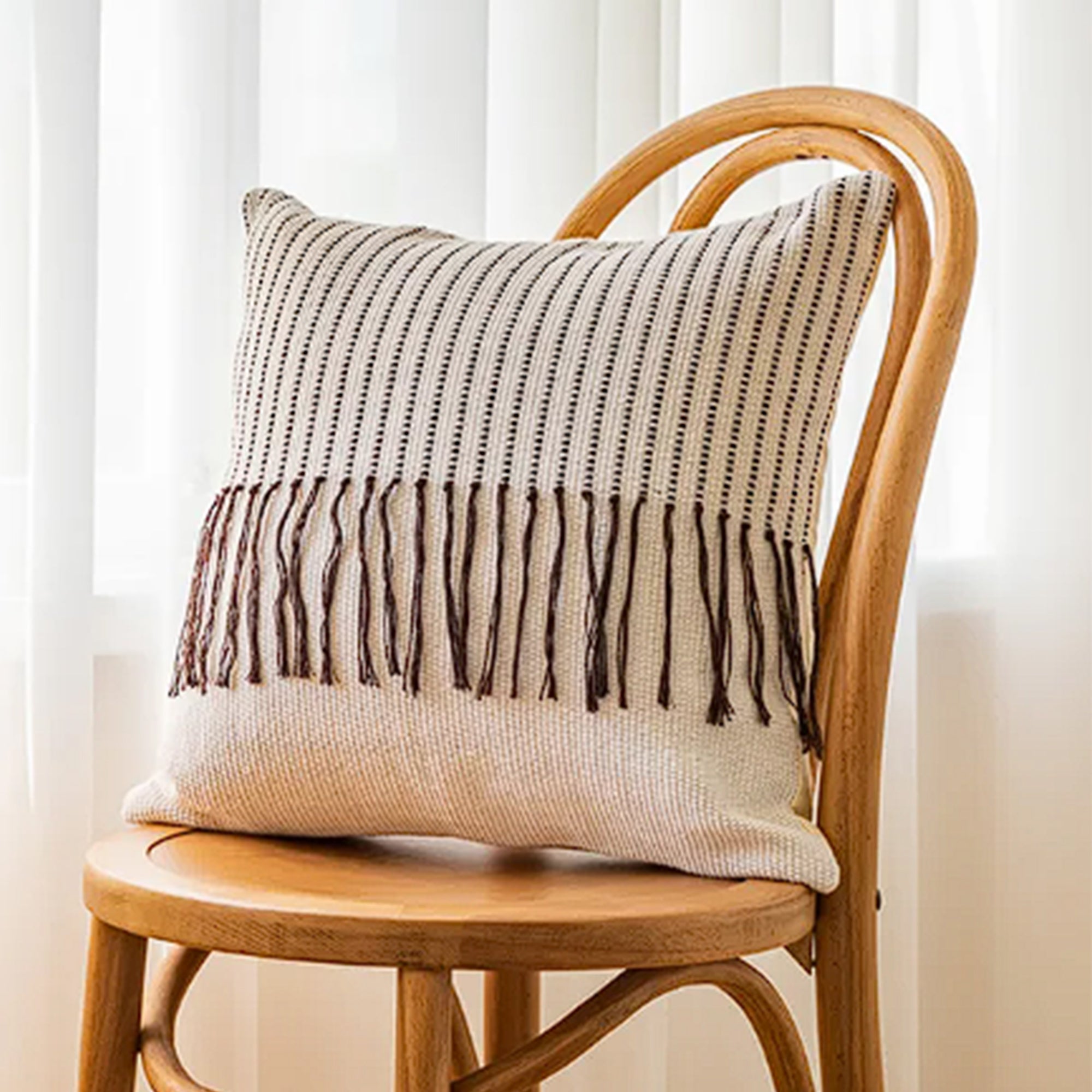 White and brown 45x45 cm tassel cushion from BEACON with decorative tassels and soft fabric, perfect for cozy sofas.