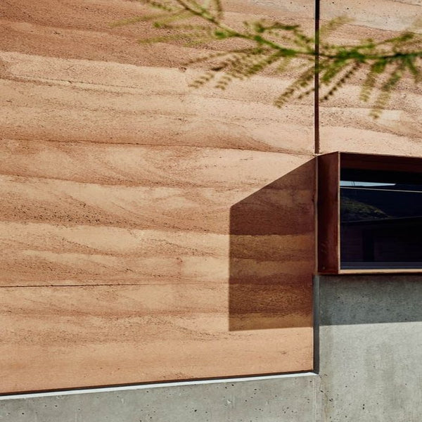 A modern living room featuring a Flexstone wall panel with a natural stone texture
