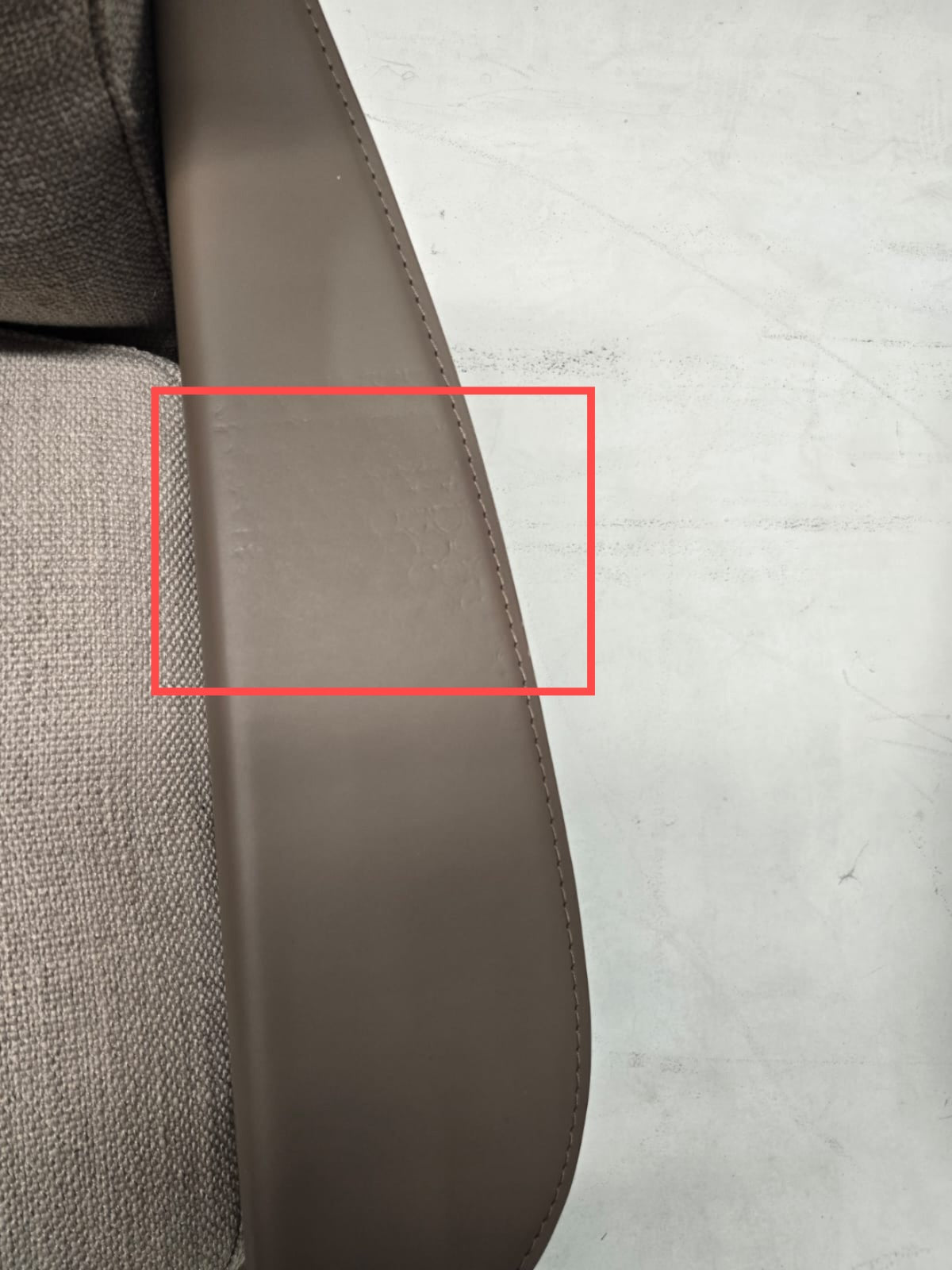 Display image of the Avenor armchair by BEACON, showing its modern design and plush upholstery in a neutral color.