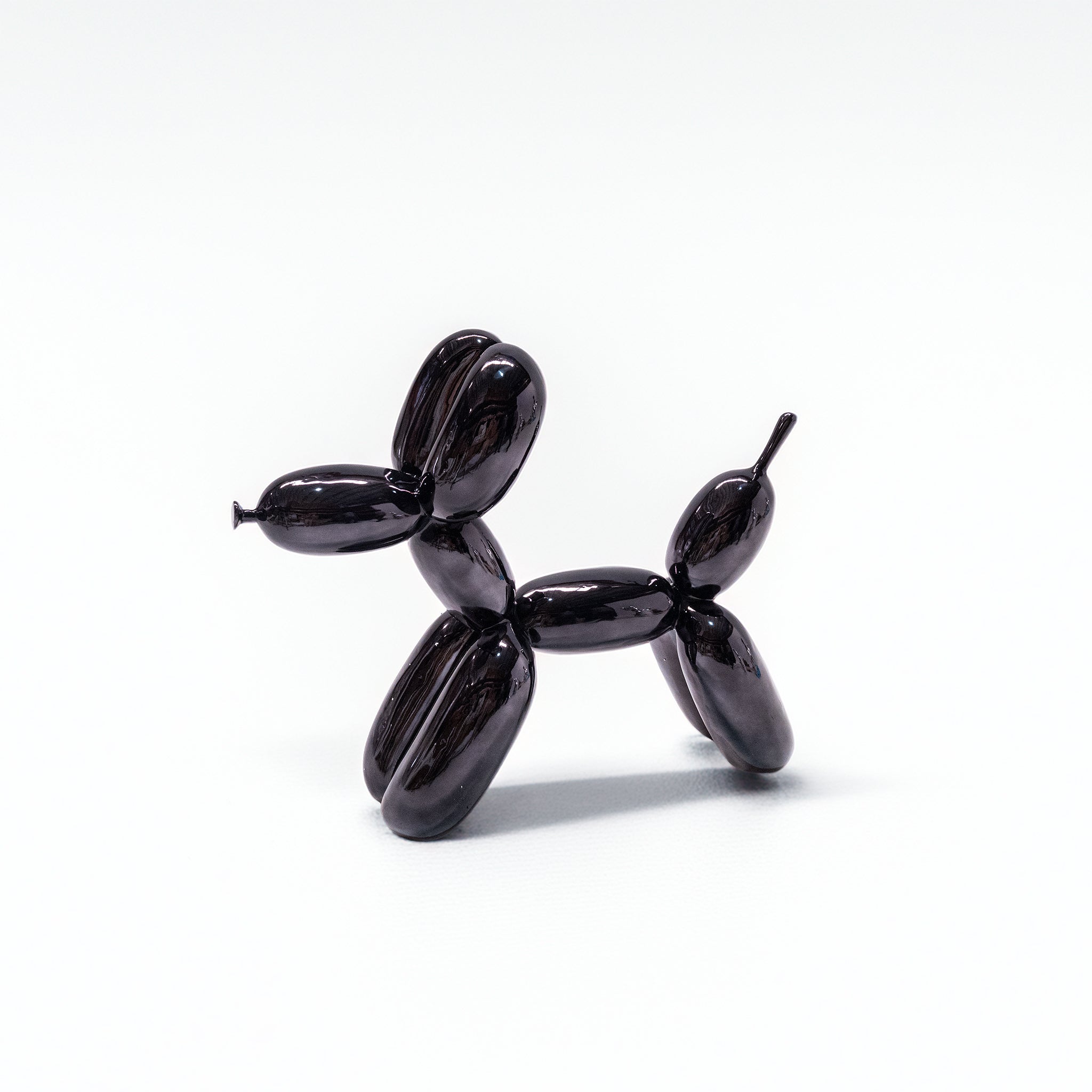 Shiny space grey fiberglass Balloon Dog sculpture by BEACON, modern artwork with smooth, reflective surface and playful design.