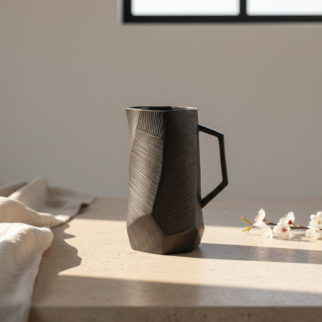 Black volcanic chiseled ceramic jug by Mingxiang Ceramics, 22338, with textured black finish and unique sculpted design.