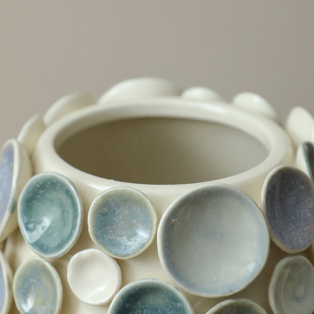 Colorful round handmade ceramic vase with glazed finish, designed by BEACON, featuring vibrant patterns and a smooth, glossy surface.