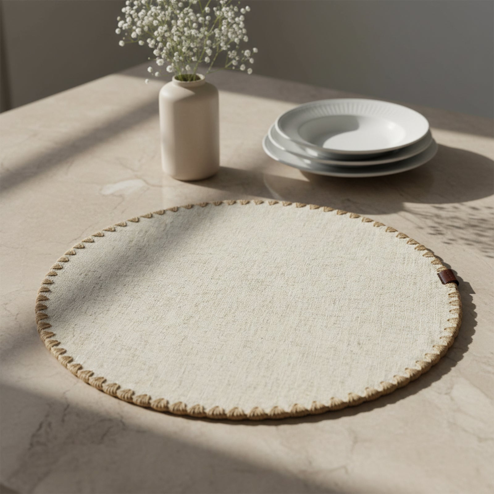 Beige Dineva placemat by BEACON with shelled edge and double layers, showcasing elegant textured design for dining tables.