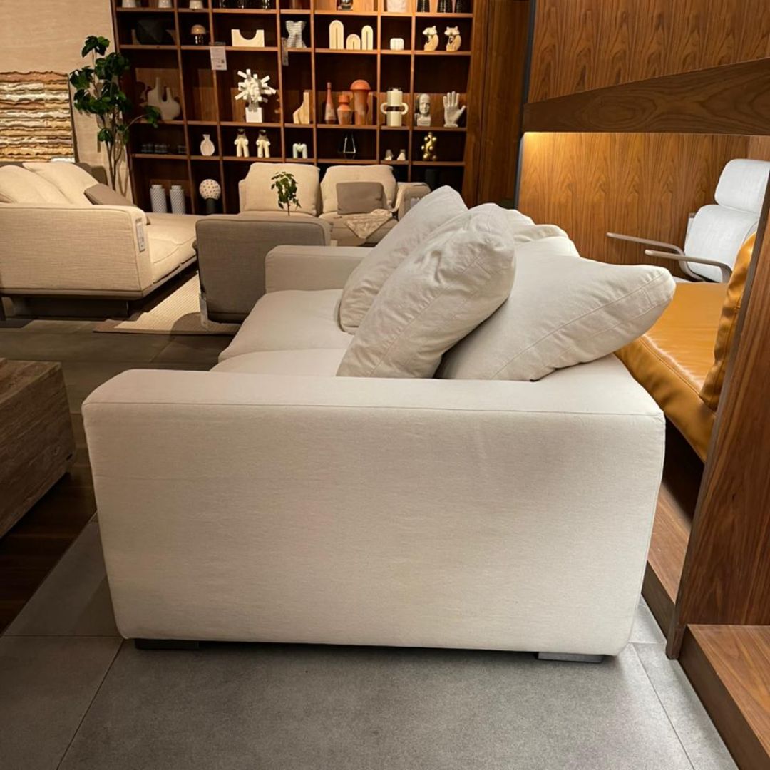 Display of BEACON CHAM 2-Seater Sofa in a showroom setting, showcasing its modern design and upholstery details.