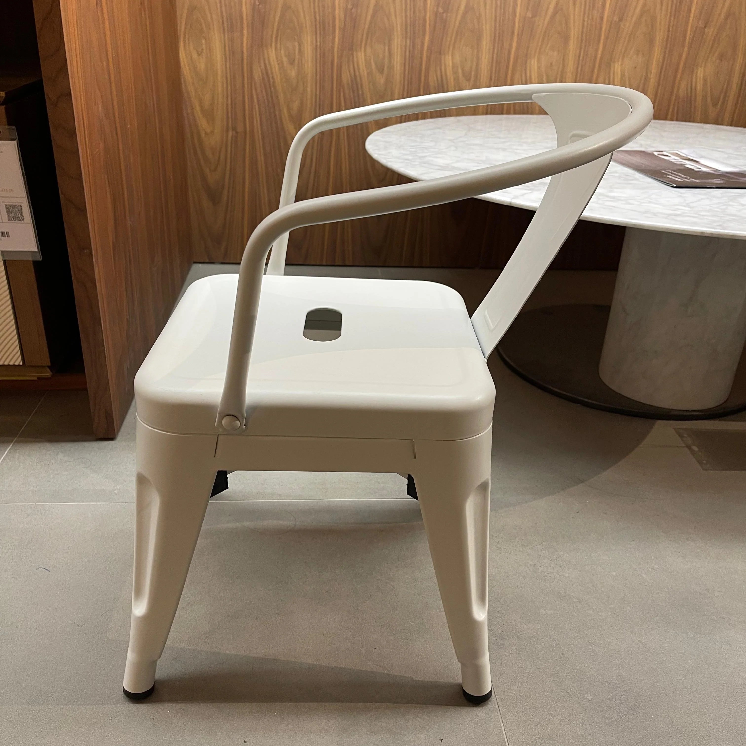 Metal kids chair in yellow with a sturdy frame, part of the RUDI K01-W collection, displayed on a showroom stand.