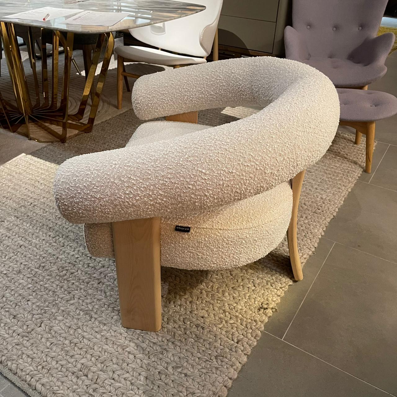 Curved back wishbone chair with brown oak legs, displayed on a white background, modern design by Sagebrook Home.