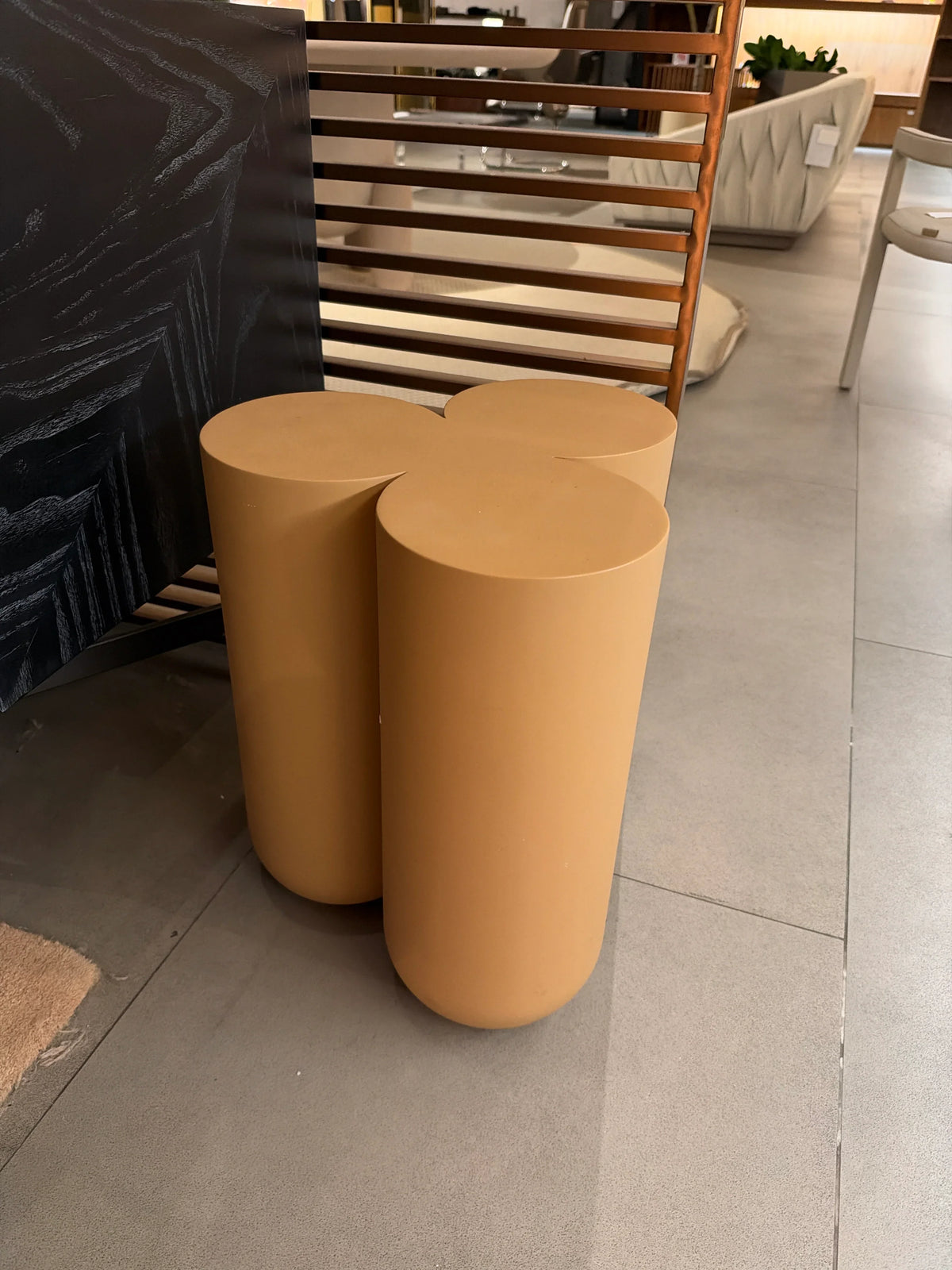 Display of a beige side table with oak and bent wood, featuring a modern design, from the Beacon Yas collection.