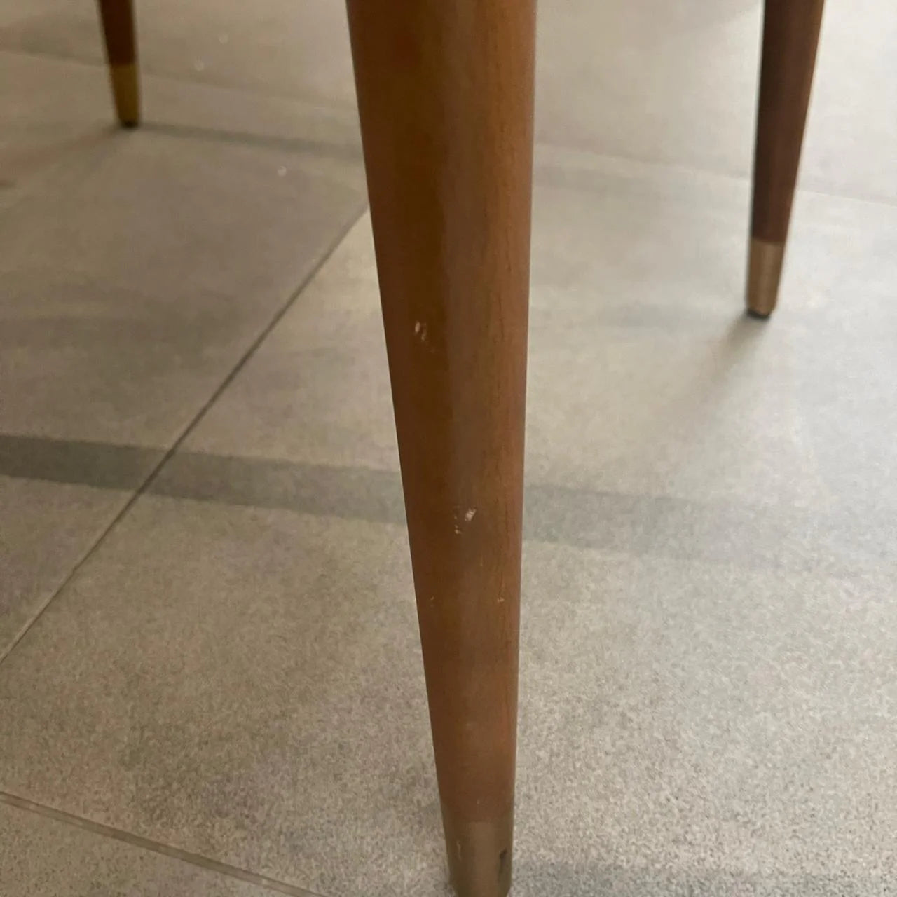 Display of the Pena dining chair by YOL Living, showcasing its modern design with wooden legs and upholstered seat.