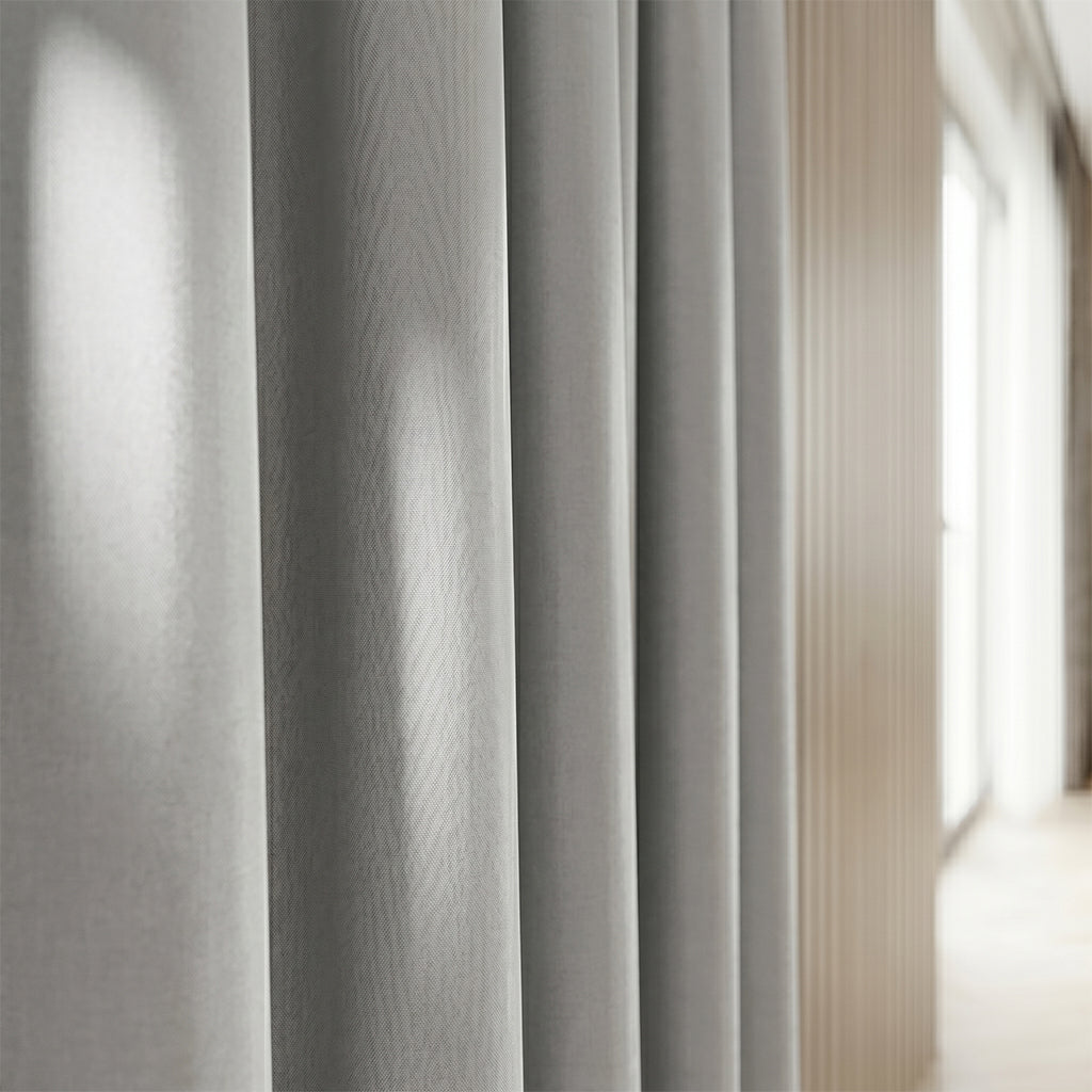 Beige flax polyester curtain fabric from BEACON, shown in close-up, highlighting its textured drape and woven pattern.